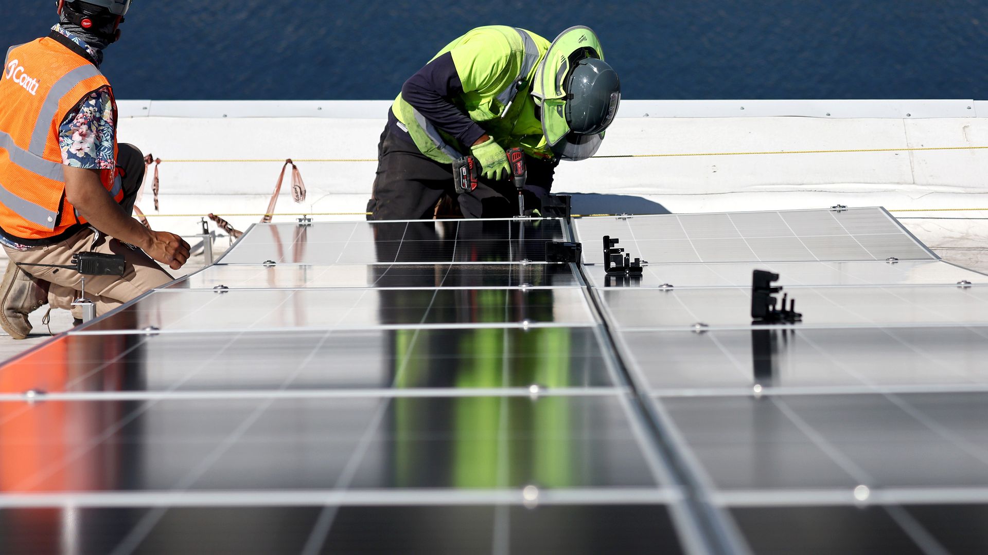 workers installing solar panels