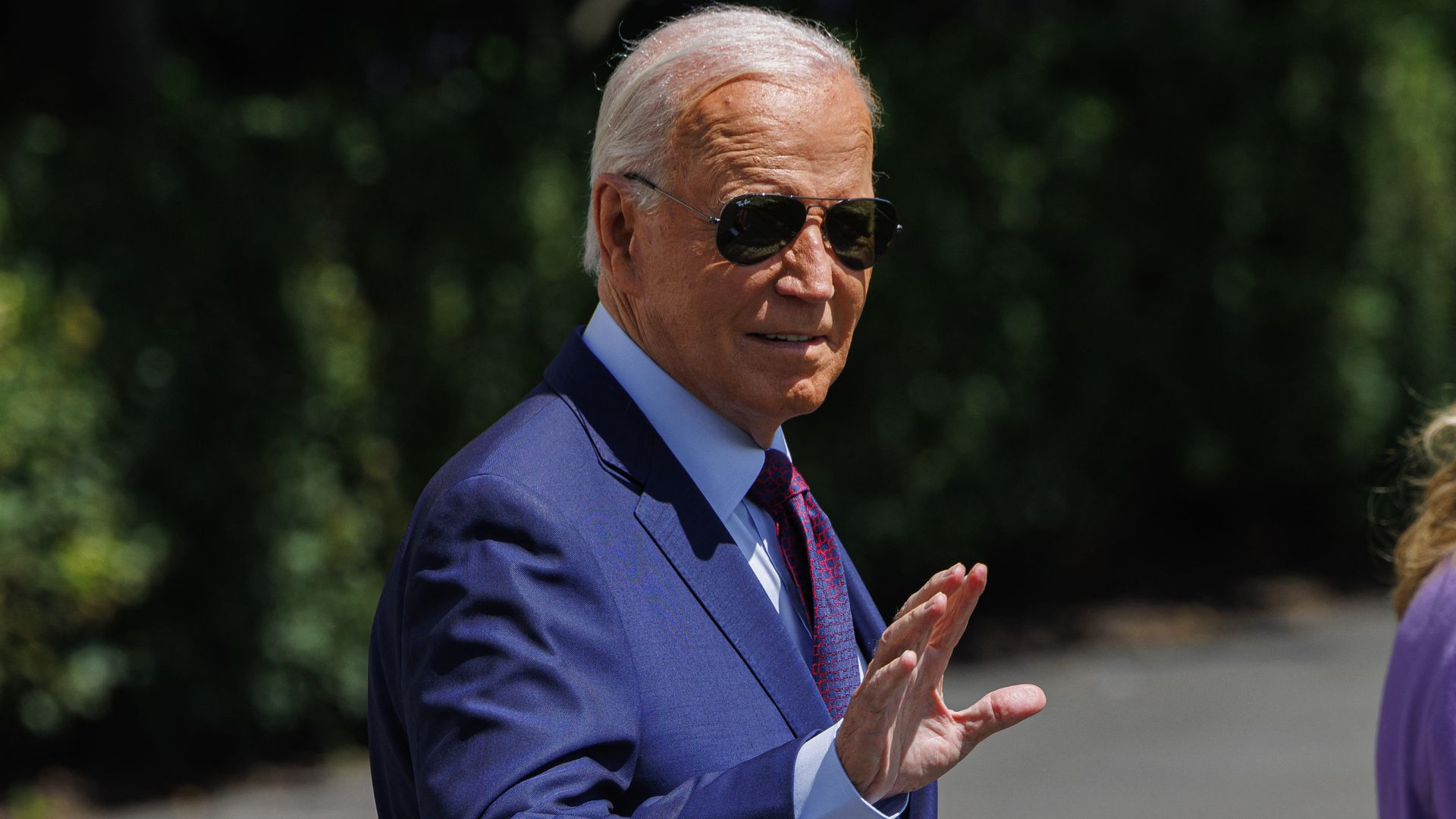 President Biden waves while walking outside