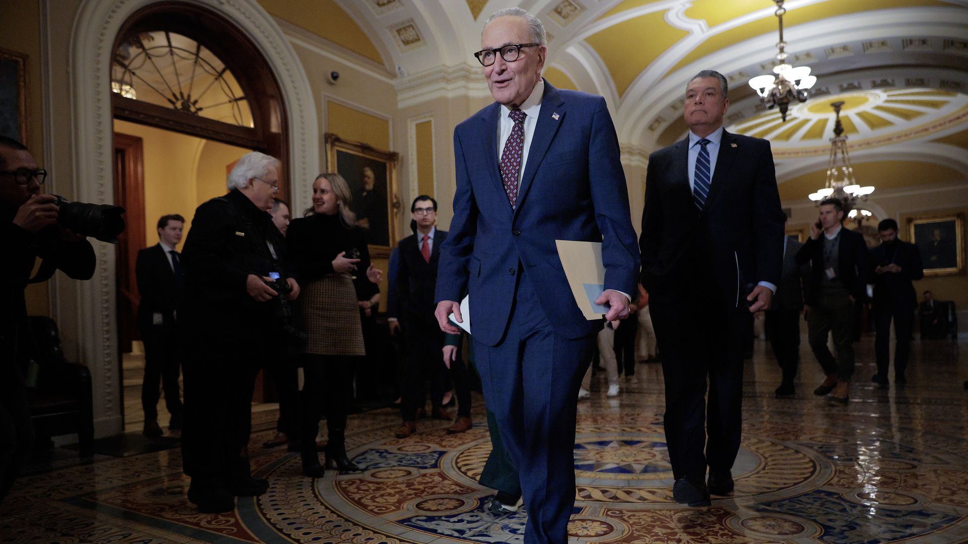 Senate Minority Leader Chuck Schumer and Sen. Alex Padilla walk to a news conference at the U.S. Capitol.