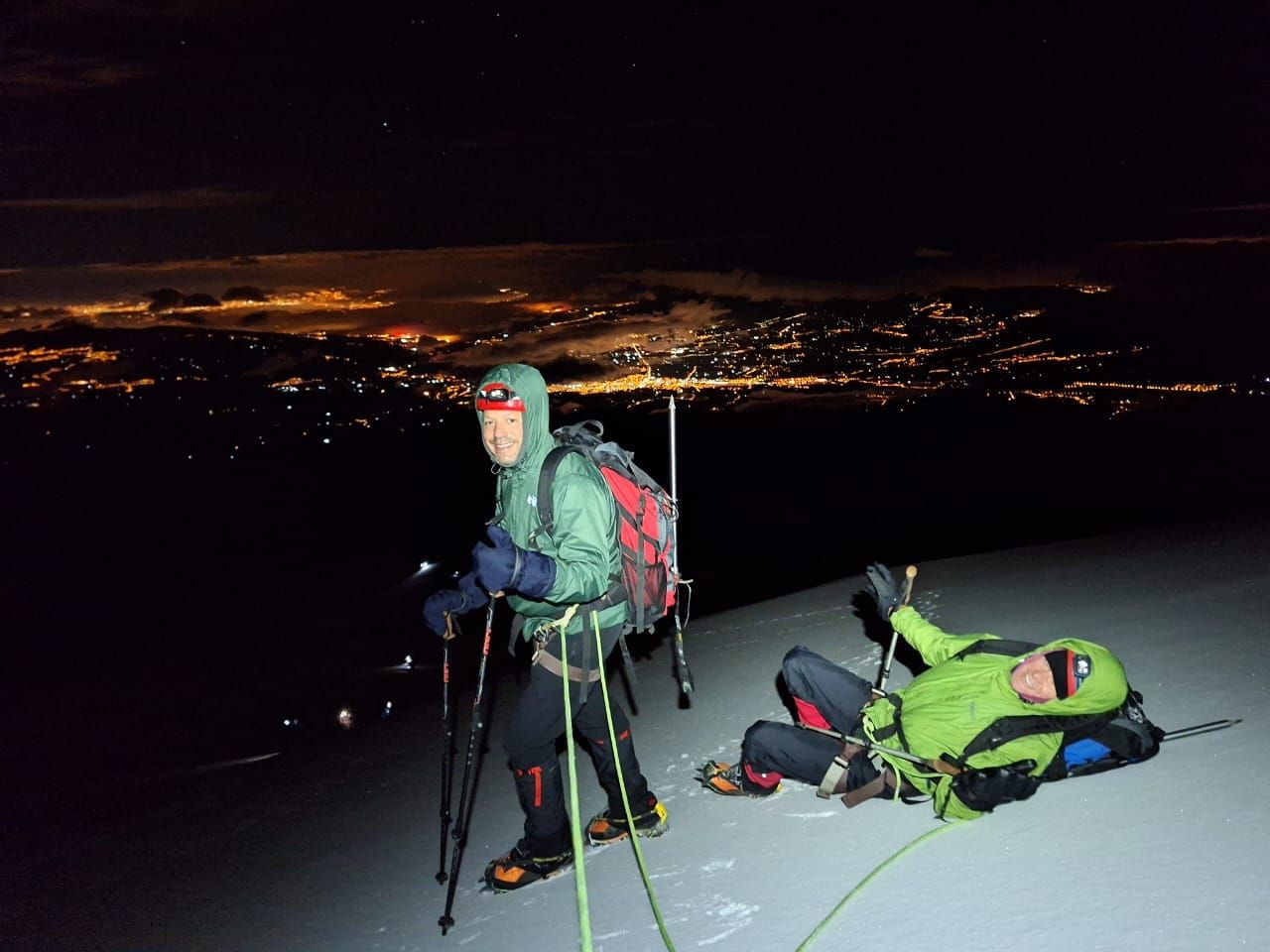 Senator Scott Surovell and his climbing companion rest on the mountain side at night