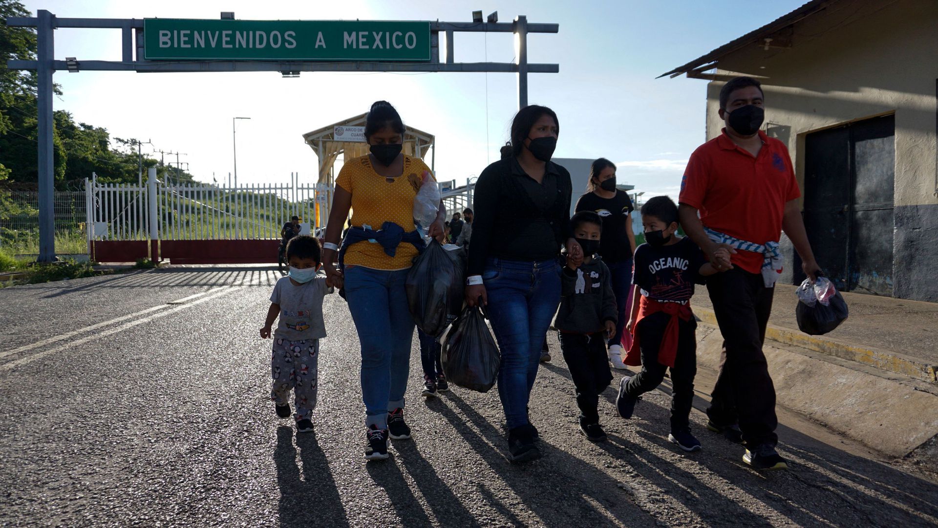 Picture of a family walking in front of a sign that reads "Welcome to Mexico"