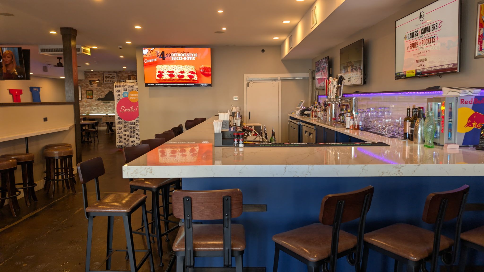 a bar with a lot of tvs