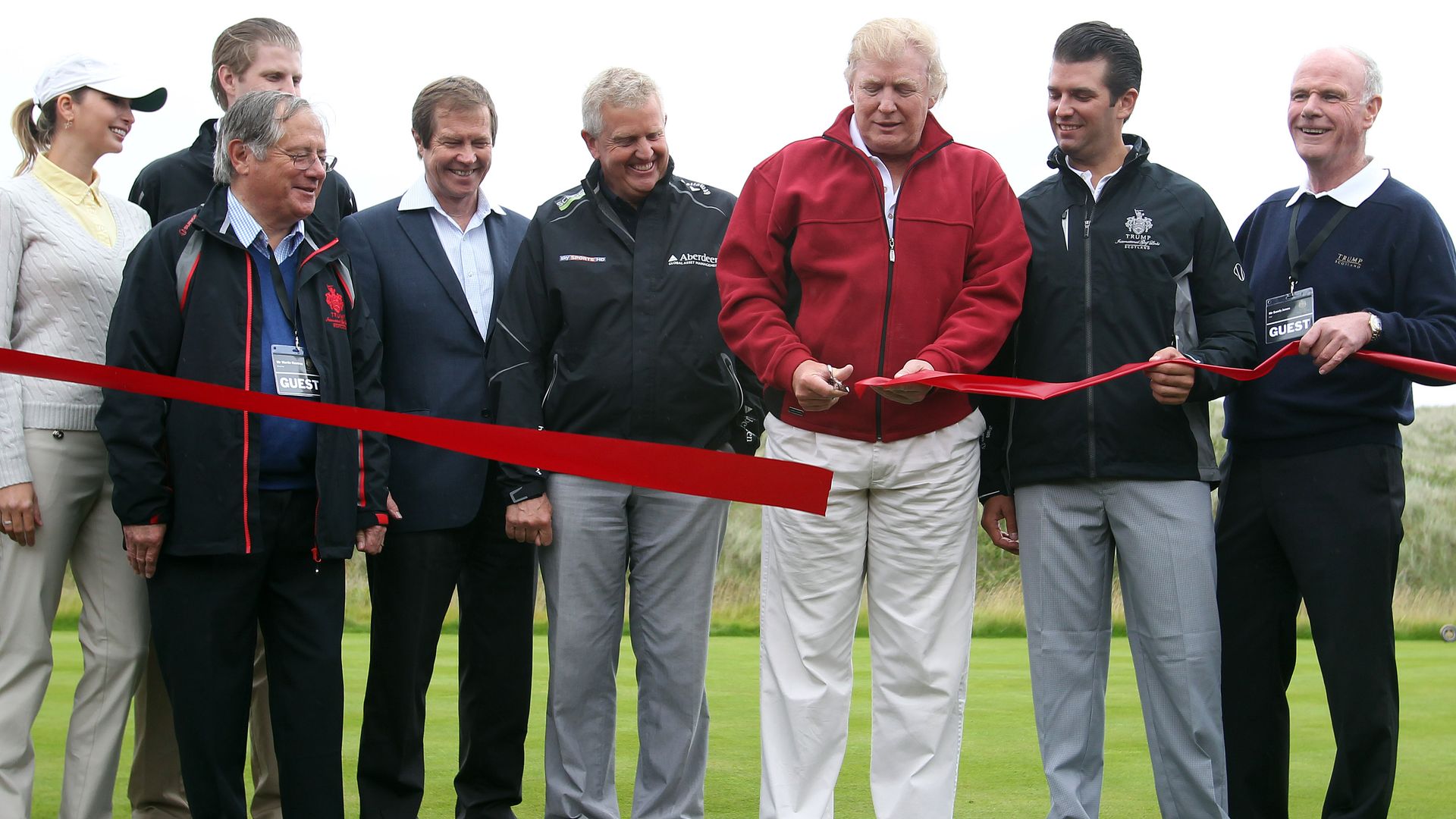 Trump cutting the ribbon to a golf course