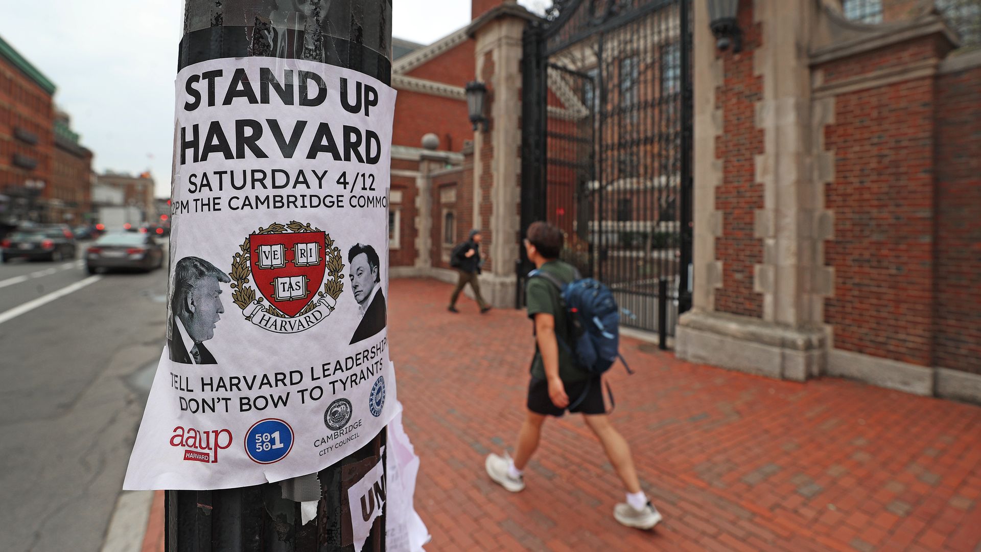 A sign on Harvard's campus reads "Stand Up Harvard" promoting a rally