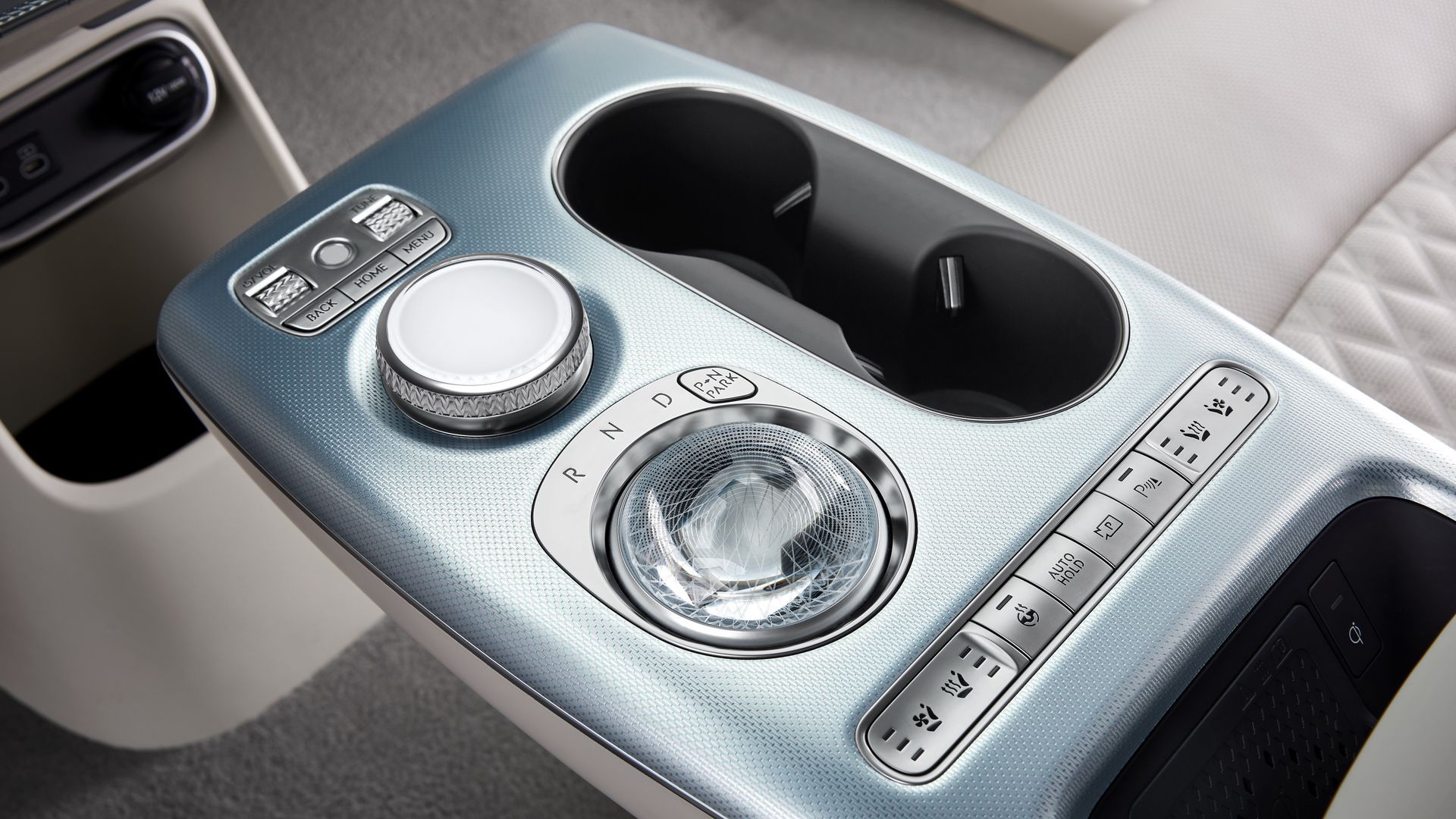 The tiny fingerprint reader (top) and the crystal ball that flips upside down to become a gear shifter on the GV60.