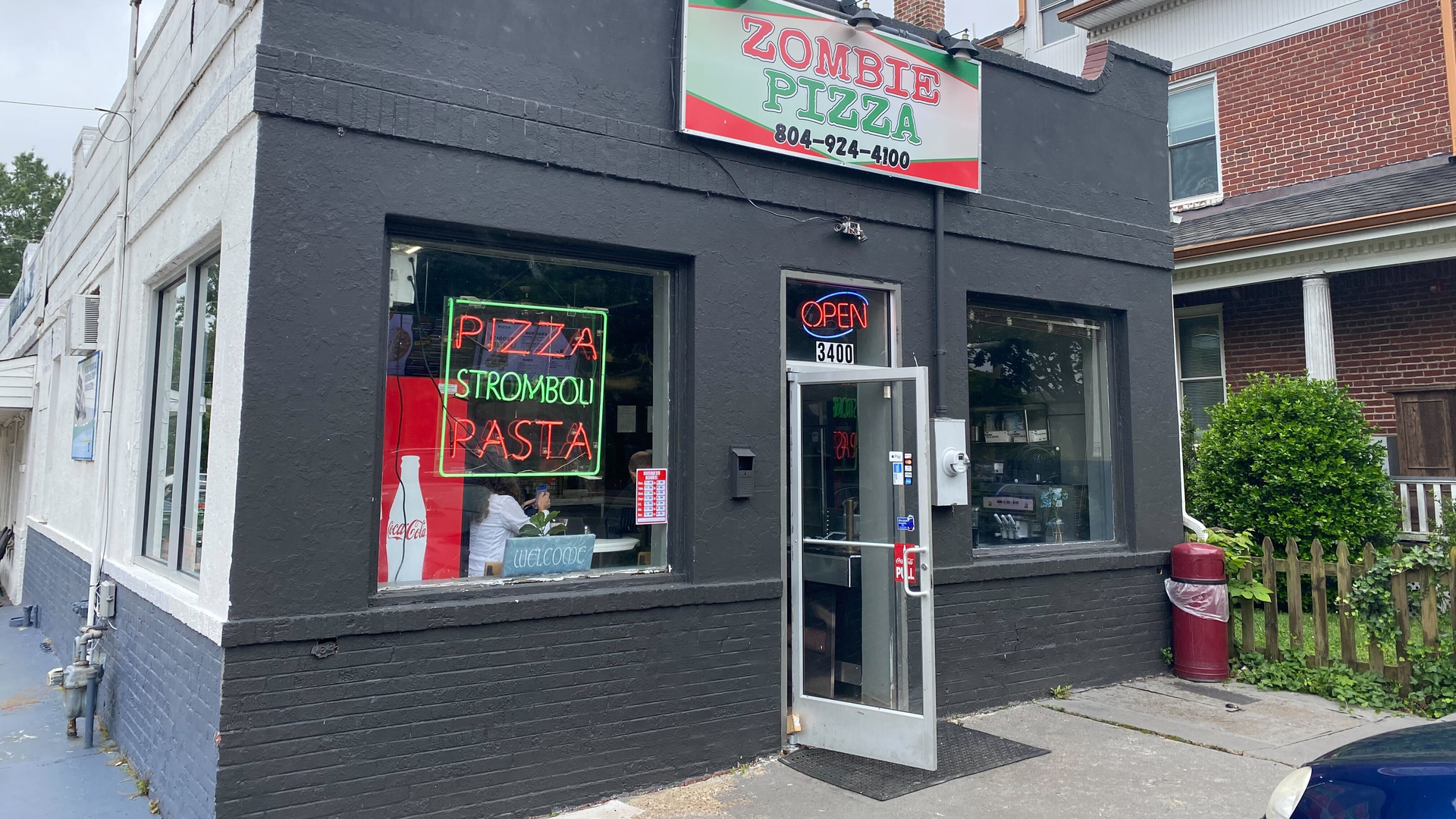 The exterior of Zombie pizza, which is a squat, brick building. 
