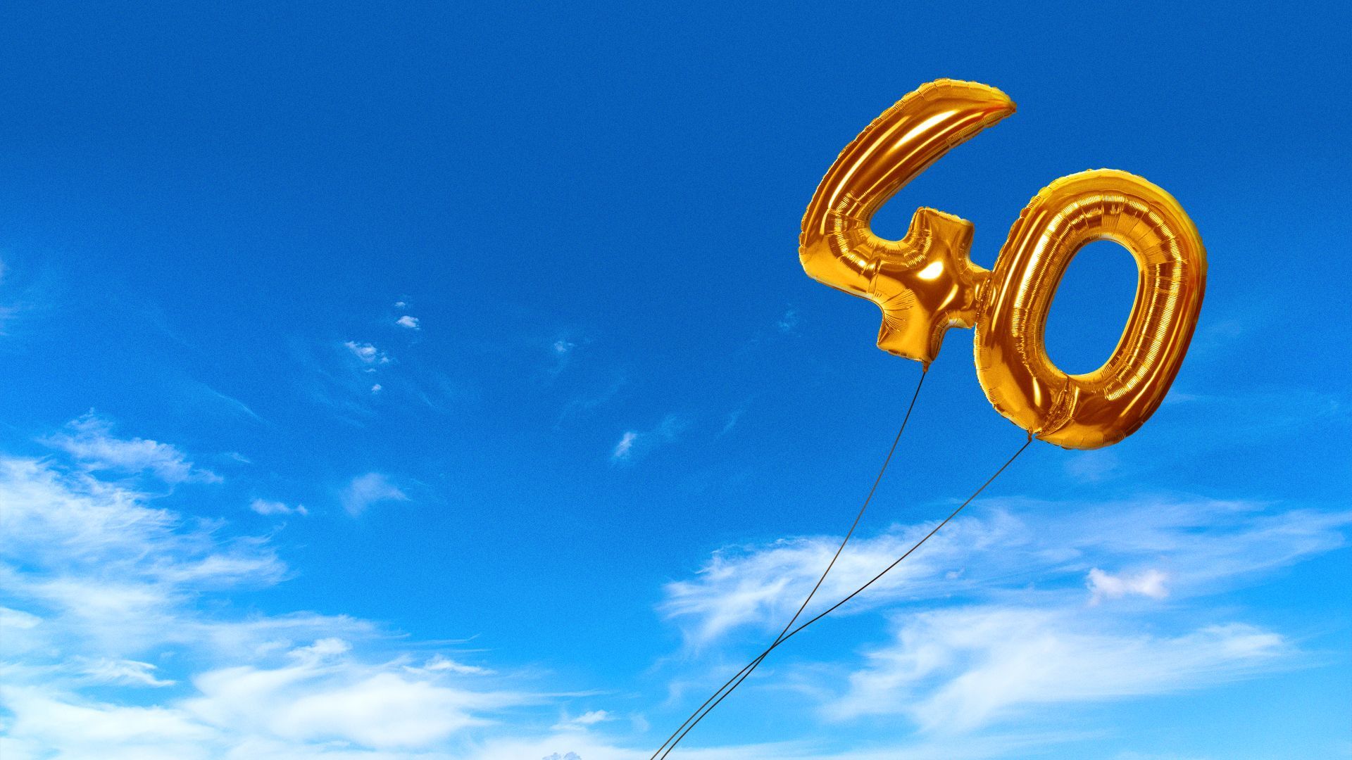 Illustration of balloons spelling "40," flying away.
