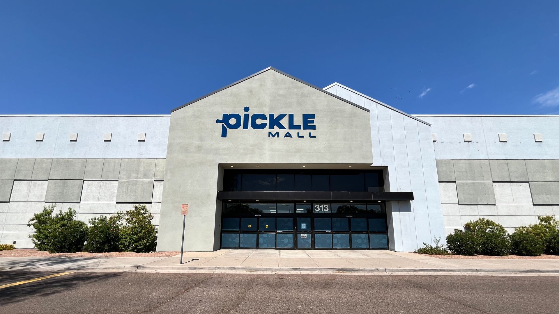 A big box store with a sign above the doors that says Picklemall.