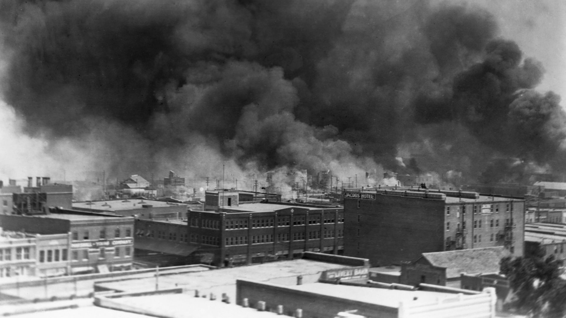 Smoke billows from fires during the Tulsa Race Massacre of 1921, in the Greenwood District of Tulsa, Oklahoma.