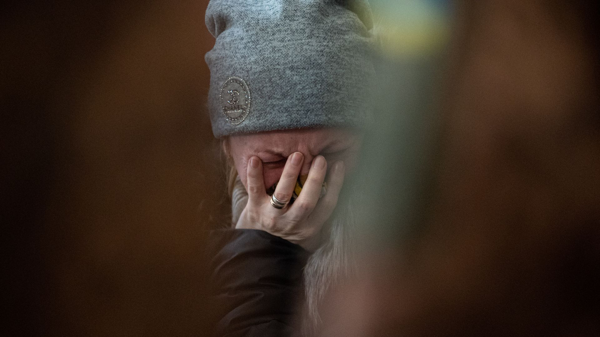 A mother of a fallen soldier cries while standing near her son's coffin in the Saints Peter and Paul Garrison Church during a funeral ceremony on December 26, 2022 in Lviv, Ukraine. 