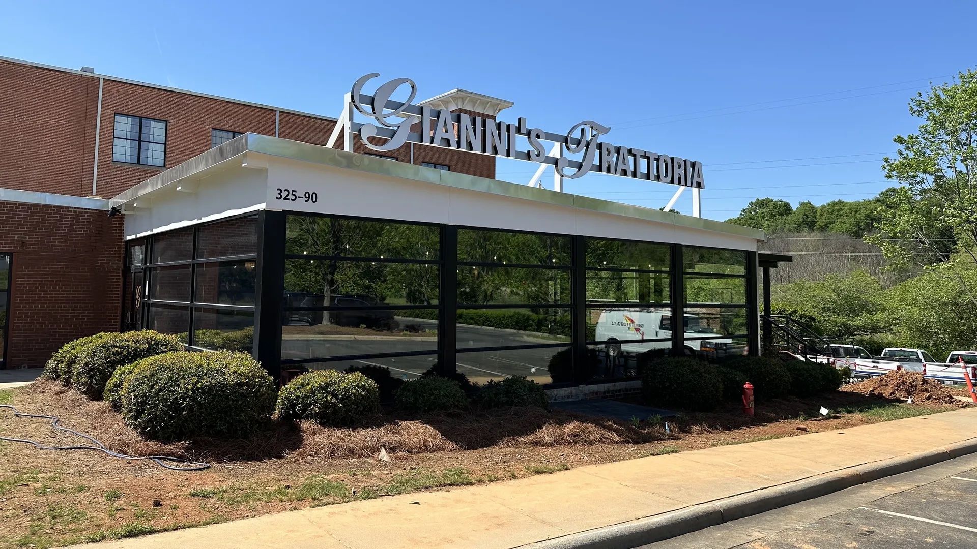 outside restaurant with sign that reads "Gianni's Trattoria"