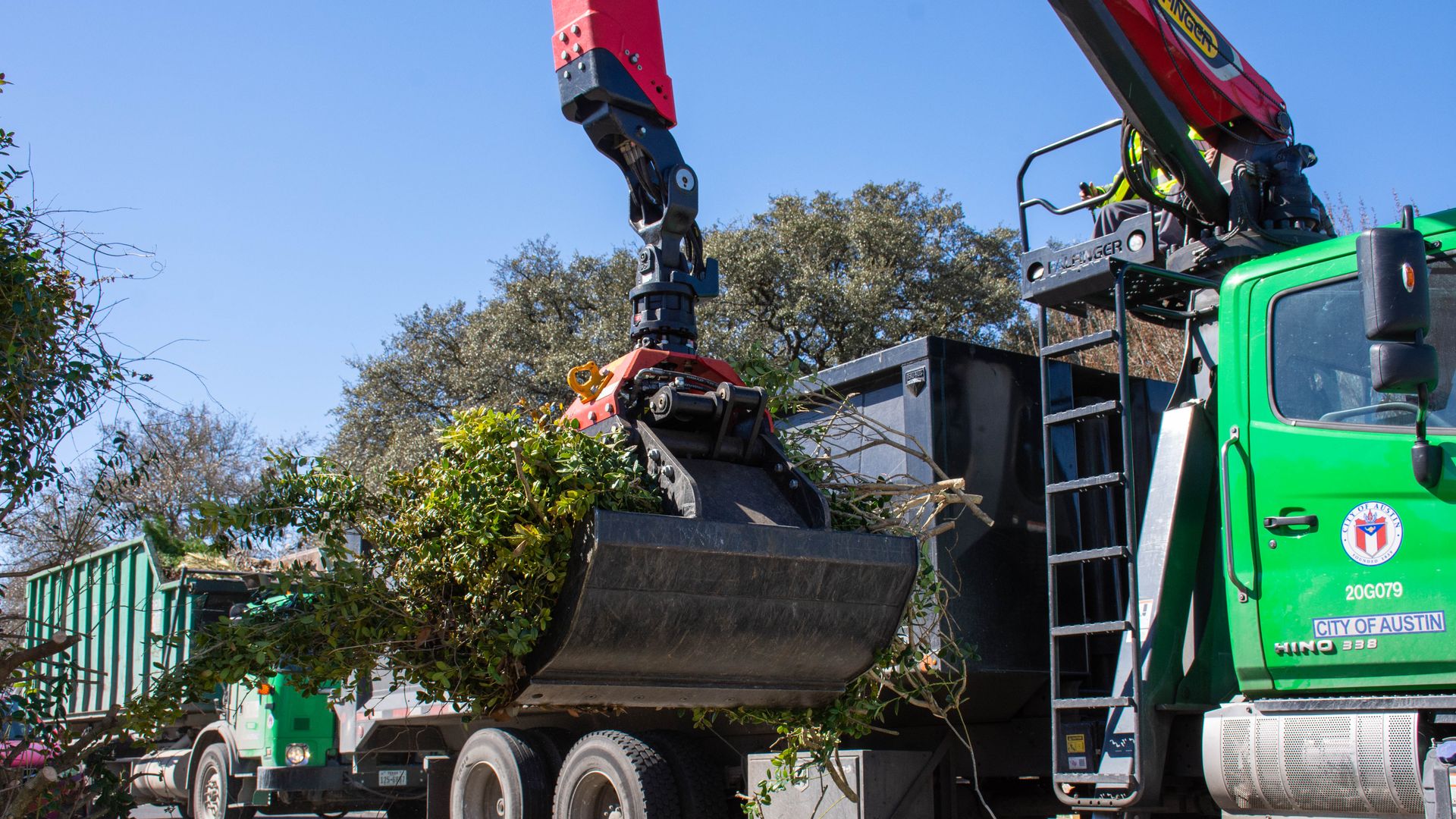 A City of Austin truck collects large brush.