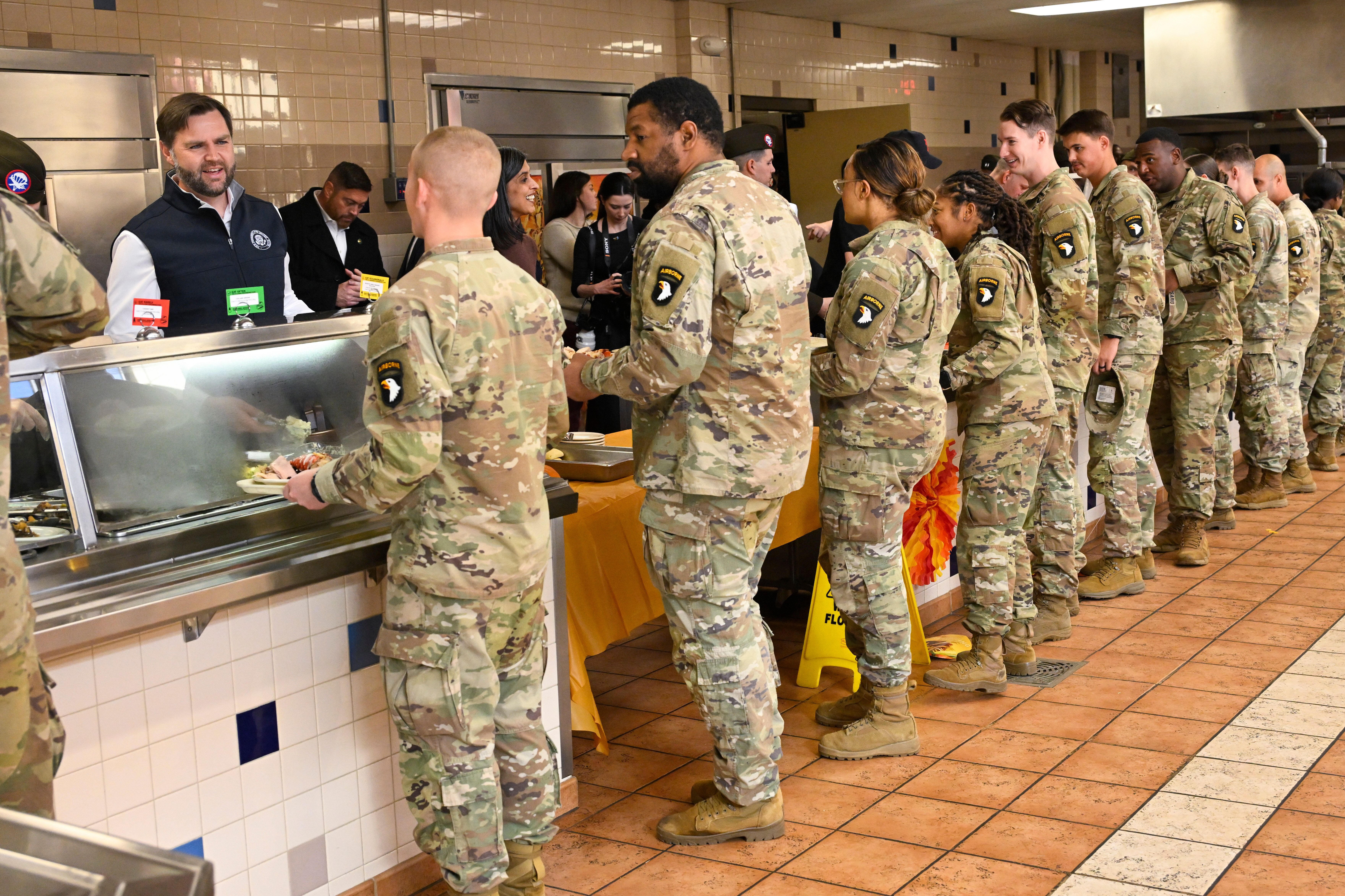 Soldiers stand in line as Vice President JD Vance helps serve a thanksgiving meal during a visit to Fort Campbell, Ky., Wednesday, Nov. 26, 2025. (AP Photo/John Amis)