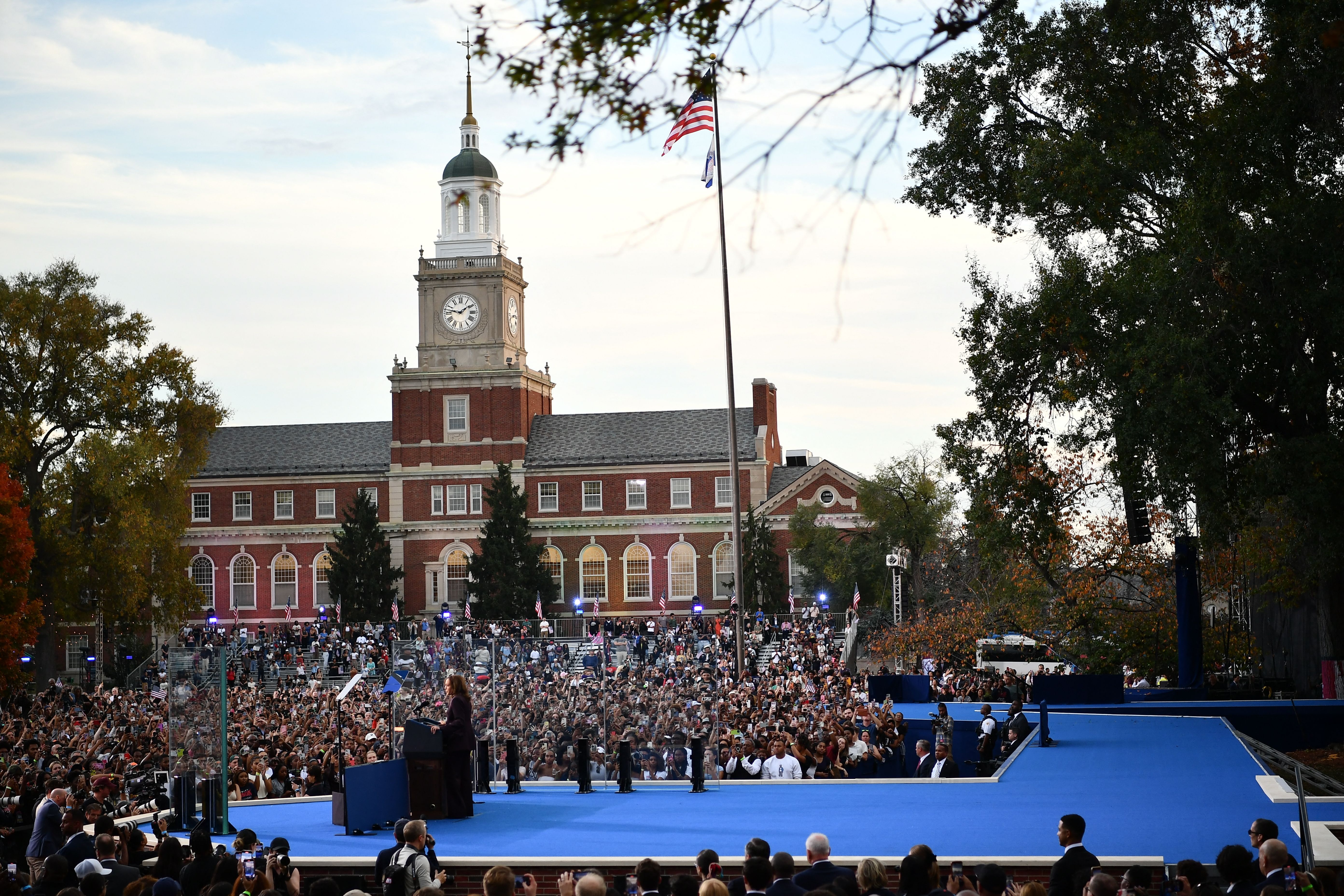 A photo showing Vice President Kamala Harris standing on a stage and addressing a crowd.
