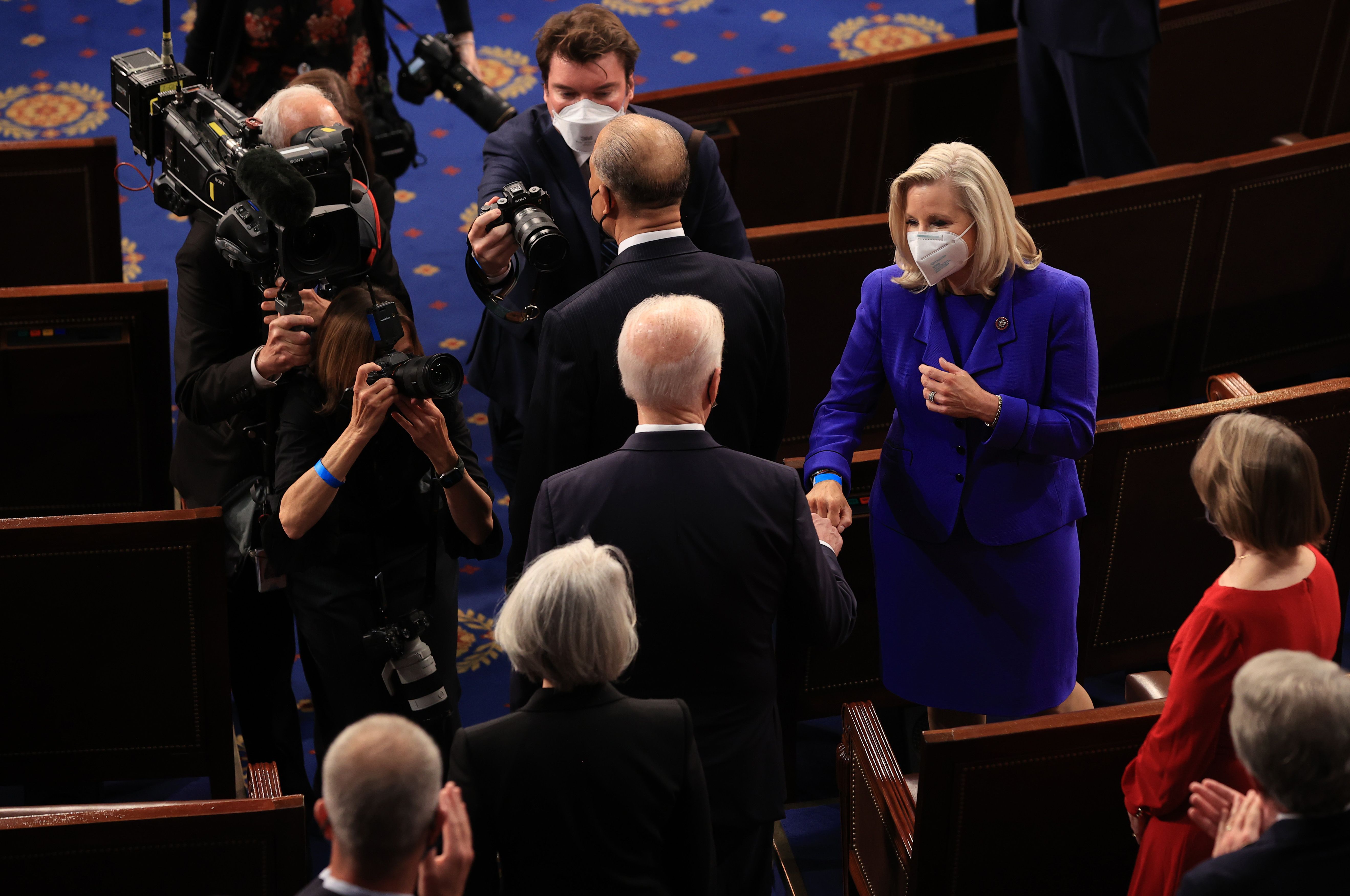  President Joe Biden greets Rep. Liz Cheney (R-WY) with a fist bump before addressing a joint session of congress in the House chamber of the U.S. Capitol 