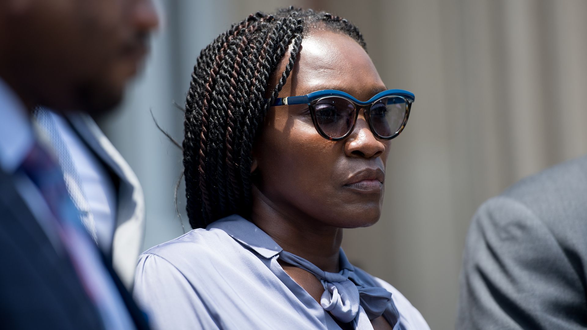 Wanda-Cooper Jones stands outside while wearing sunglasses