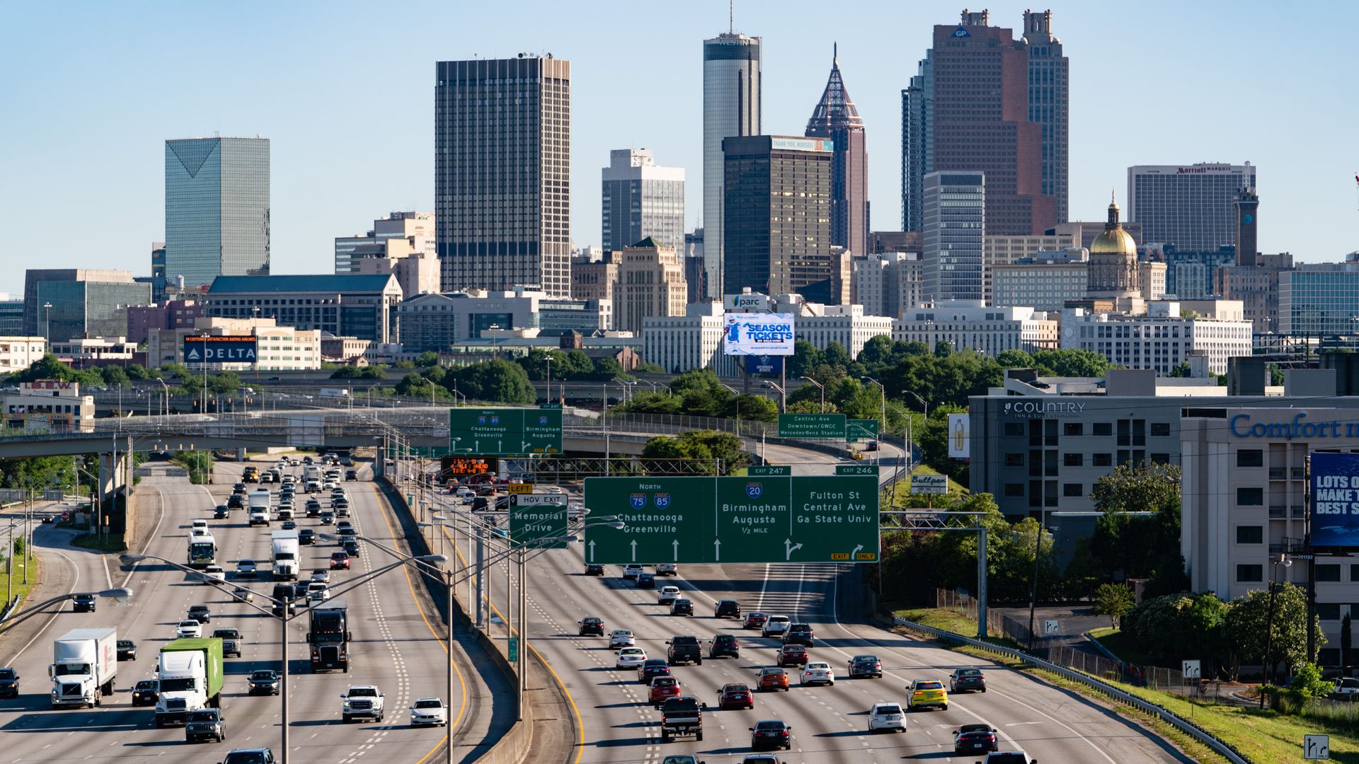 A photo of daytime interstate traffic traveling into and out of Downtown Atlanta