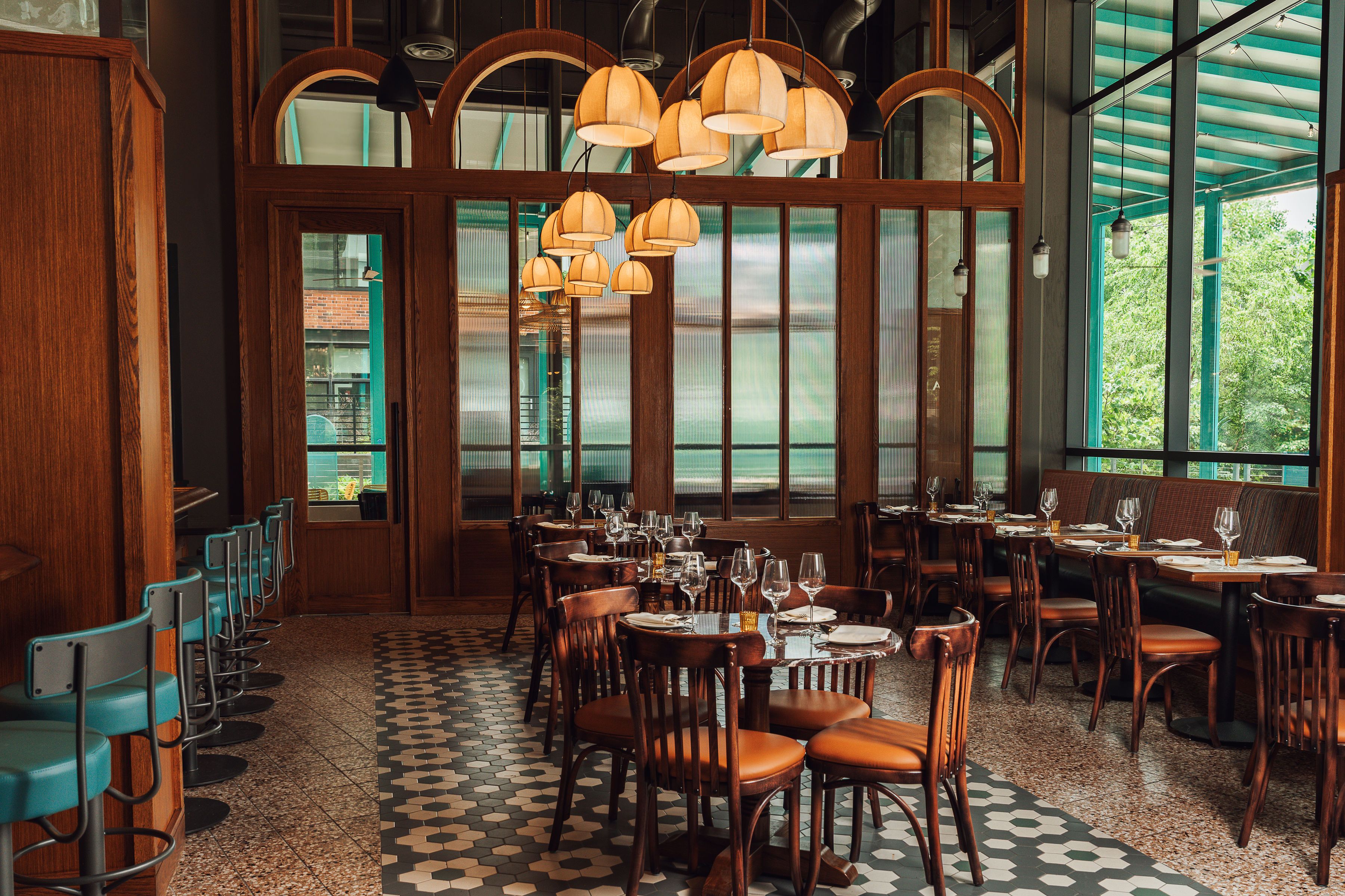 A dining room with wood panelling and tile floors