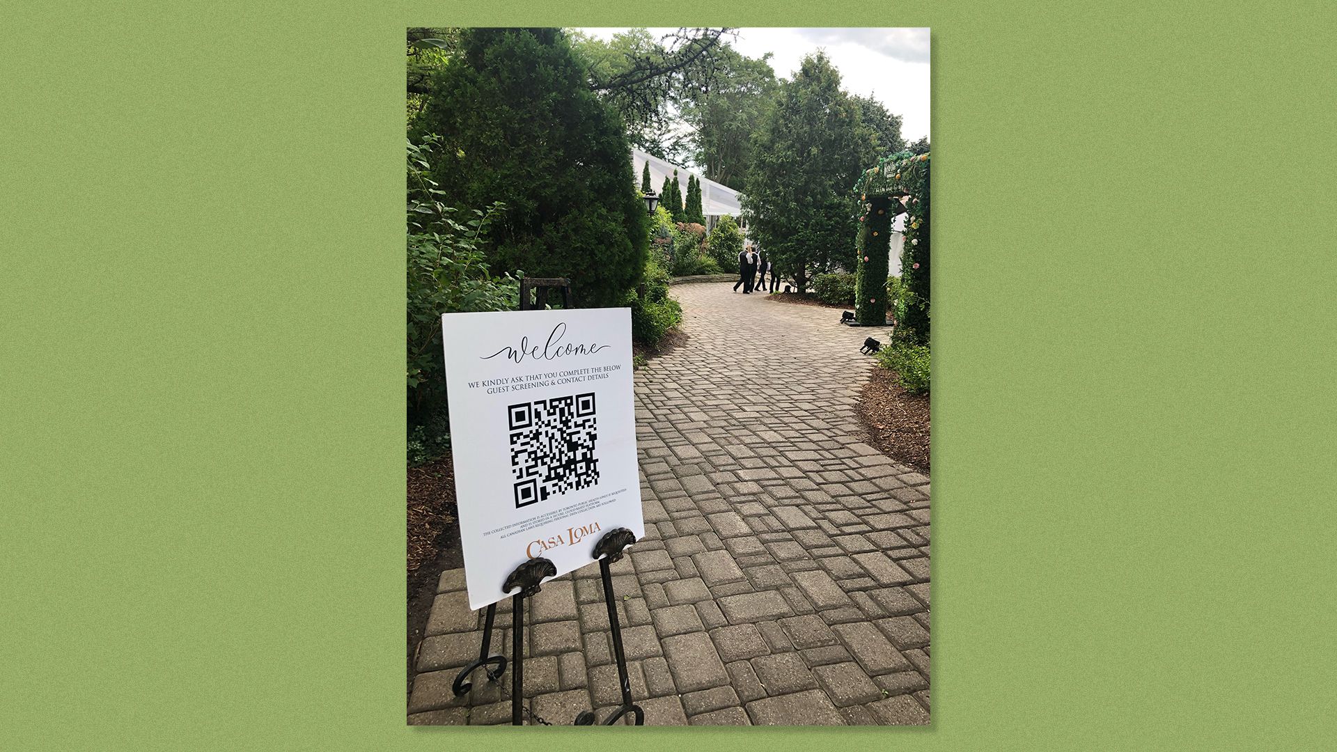 A QR code posted in front of a wedding venue invites people to scan it.