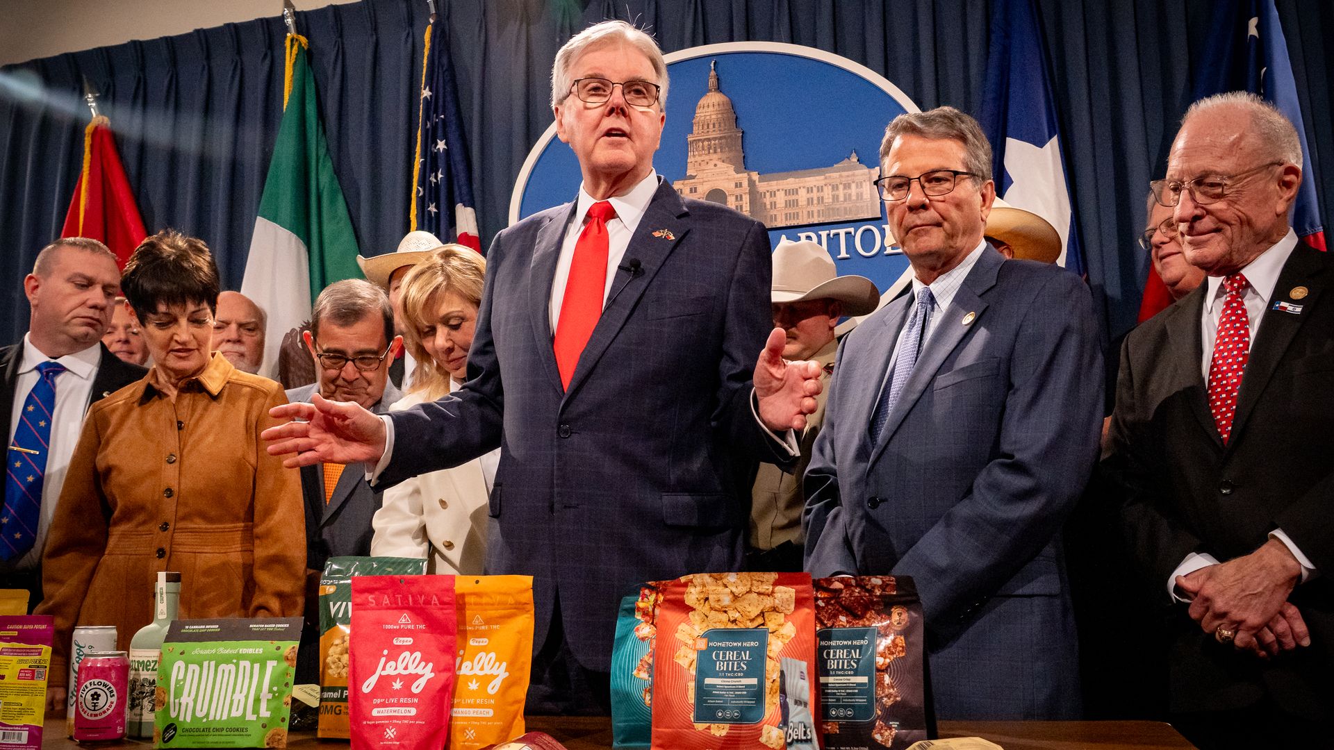 Lt. Gov Dan Patrick, surrounded by Republican lawmakers, gestures as he displays dozens of THC products at the state capitol 
