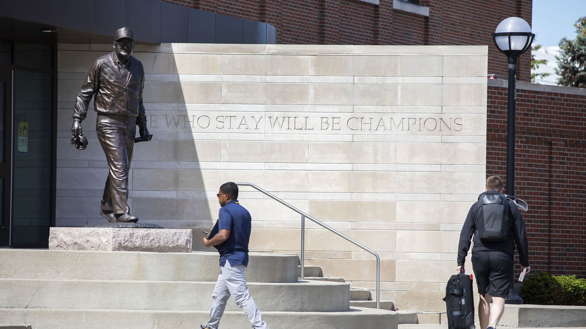 A statue of former University of Michigan football coach Bo Schembechler stands outside of Schembechler Hall on the UM campus .