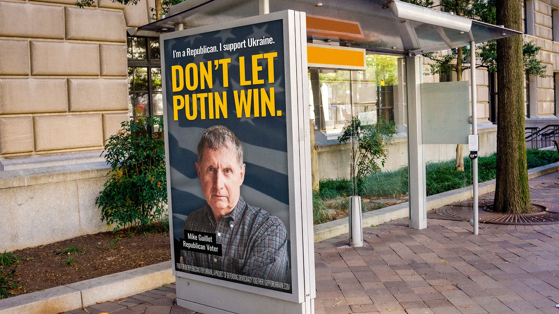 A bus stop with a large billboard reading "DON'T LET PUTIN WIN."