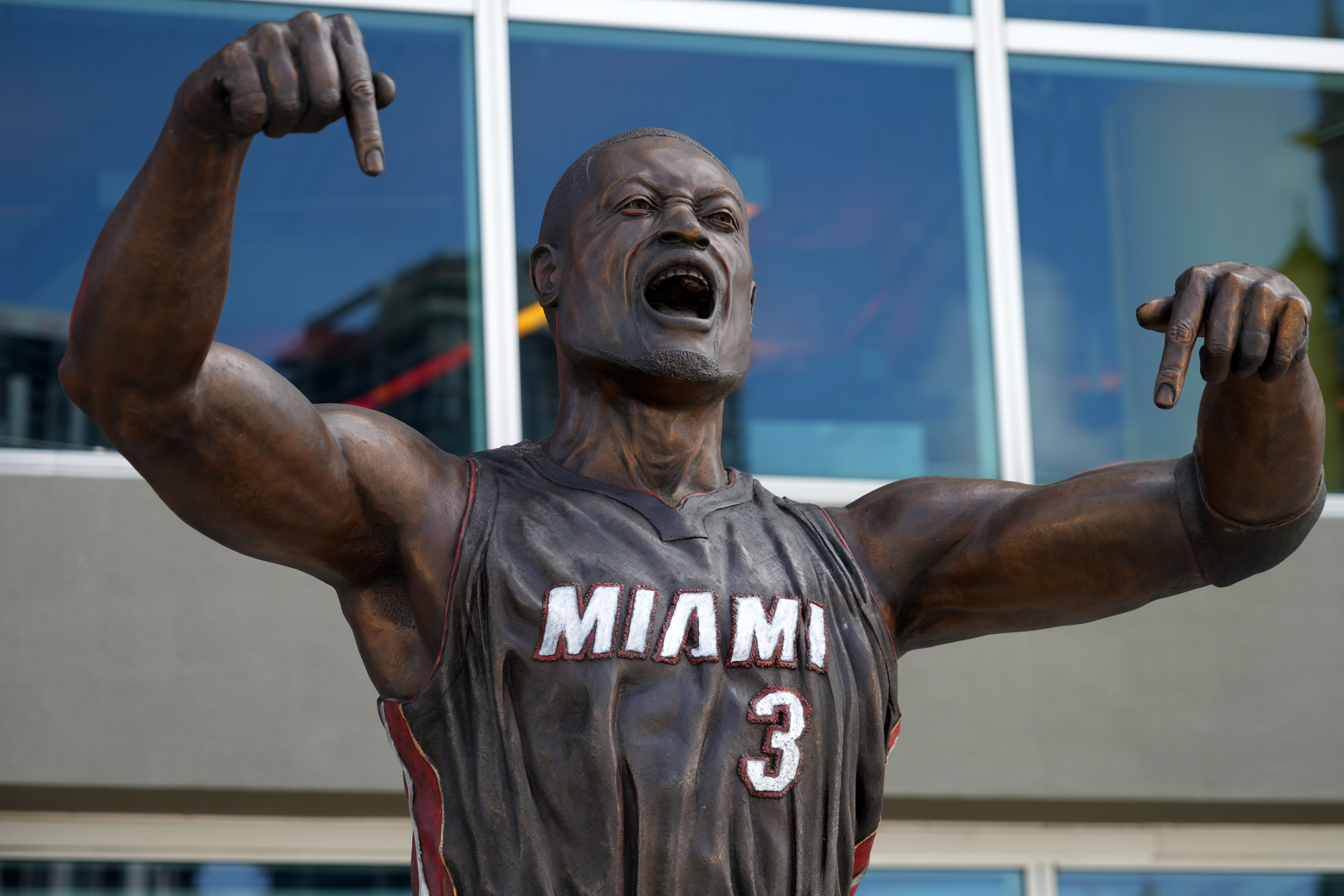 The old Dwyane Wade statue with a boxier chin. The statue is yelling with fingers pointing down to say "This is my house"