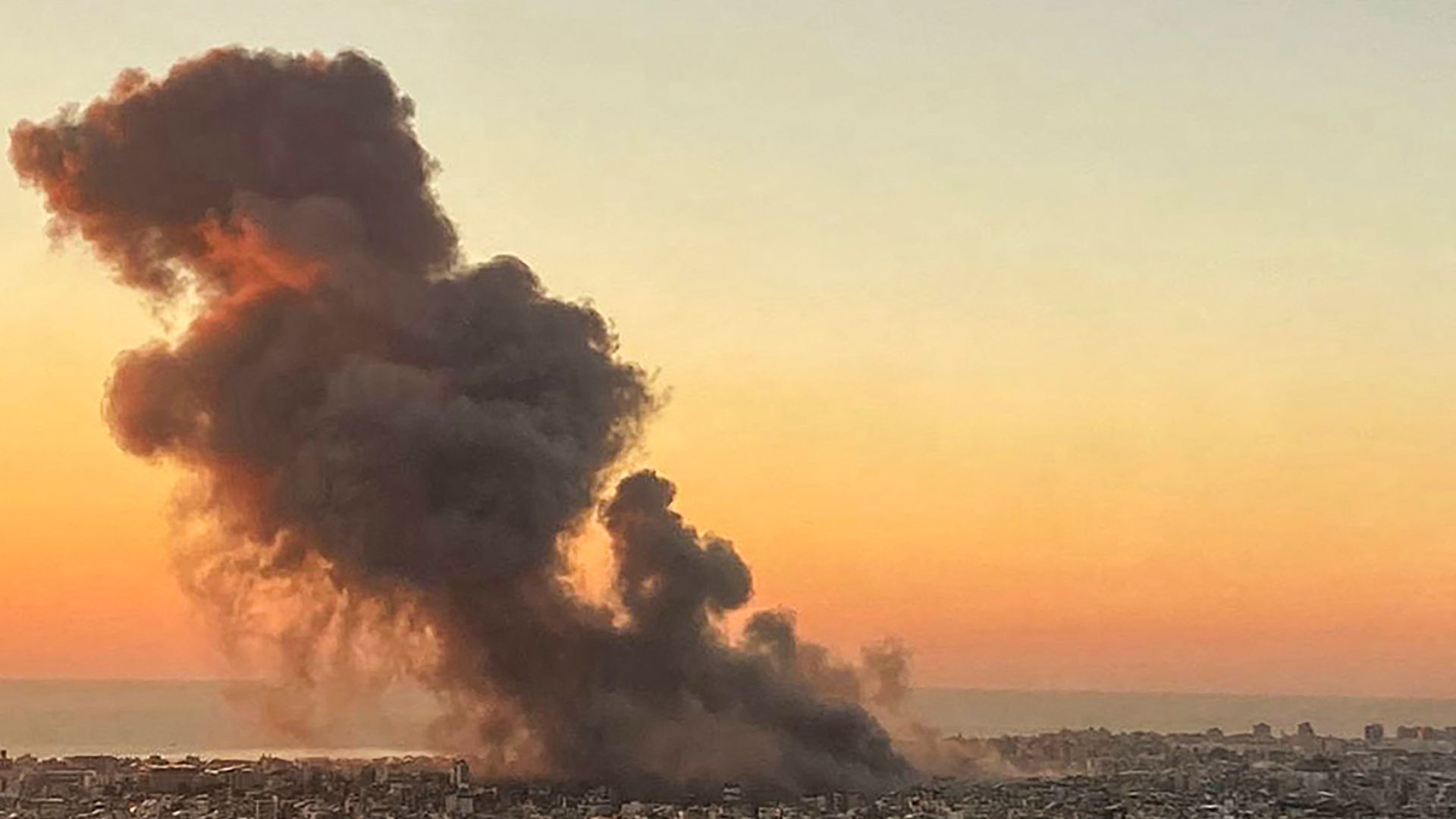 Smoke rises above Beirut's southern suburbs after an Israeli strike.