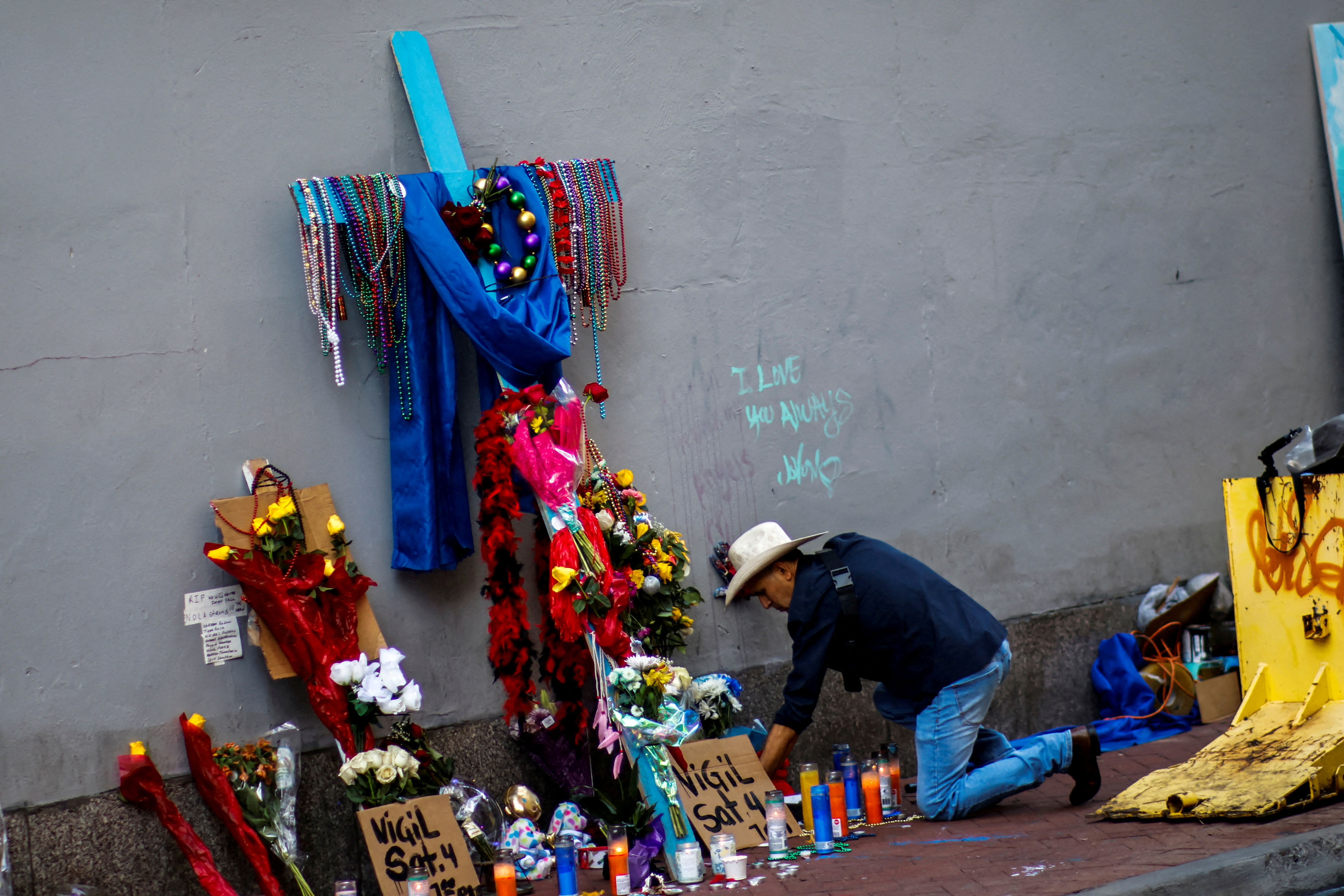 man organizes candles in a makeshift memorial for the victims at Bourbon Street two days after a U.S. Army veteran drove his truck into the crowded French Quarter on New Year's Day in New Orleans, Louisiana, U.S. January 3, 2025. REUTERS/Eduardo Munoz