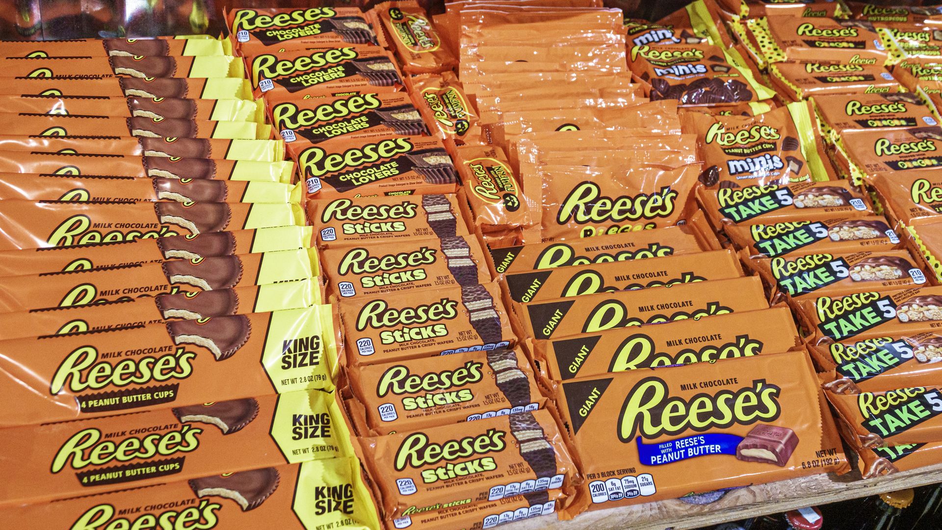 A display shows rows and rows of Reese's peanut butter candy in orange packages.