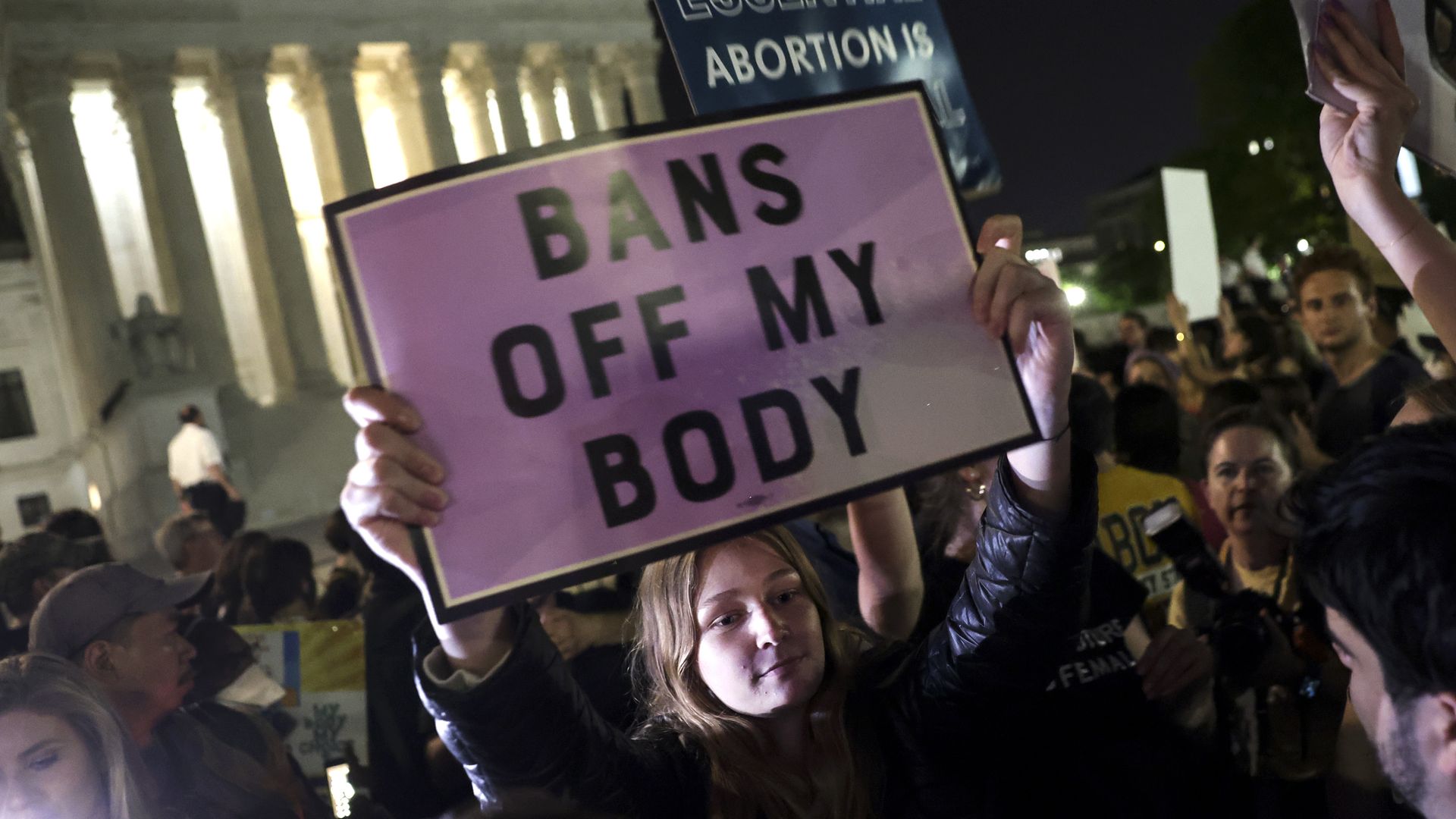 A person holds a sign in support of abortion access outside the Supreme Court