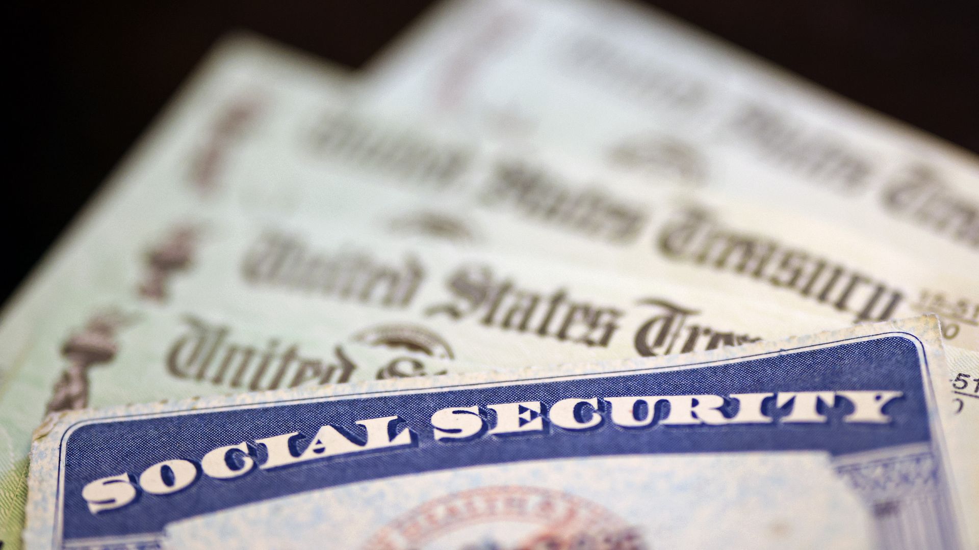 A Social Security card sits alongside checks from the U.S. Treasury. Photo: Kevin Dietsch/Getty Images