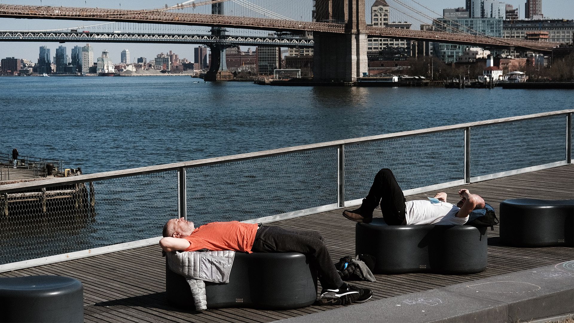 People relax in the sun in Manhattan on a warm afternoon.