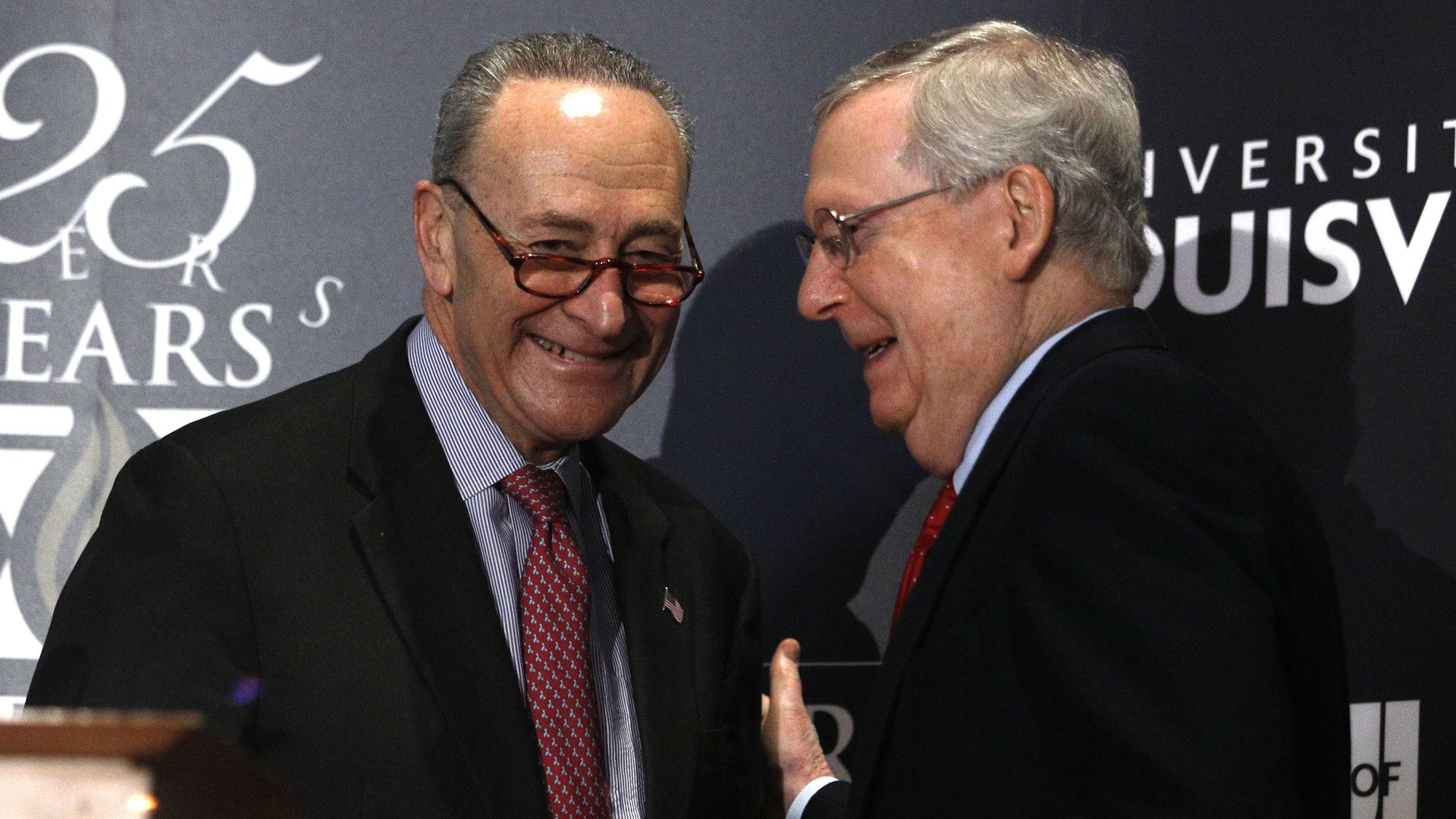 Mitch McConnell and Chuck Schumer smiling.