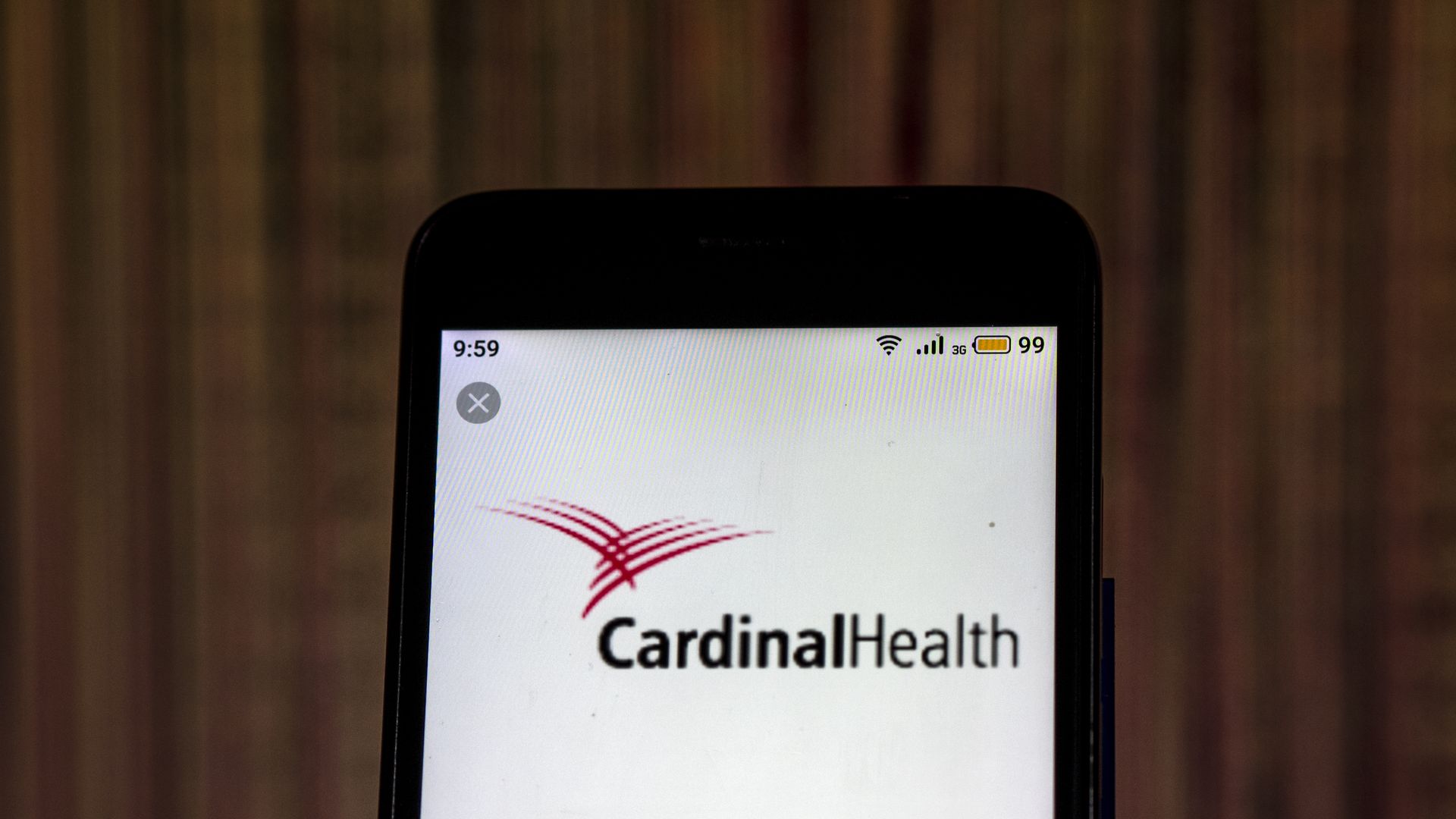 A smart phone with the Cardinal Health logo on the screen.