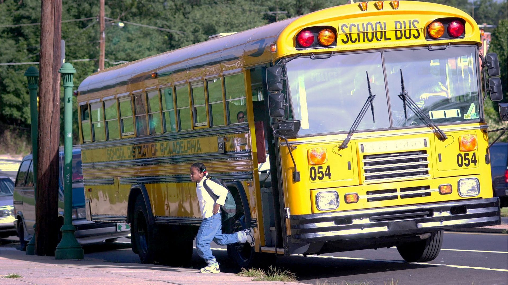 An unidentified student exits the bus on her way to school. Photo: William Thomas Cain/Getty