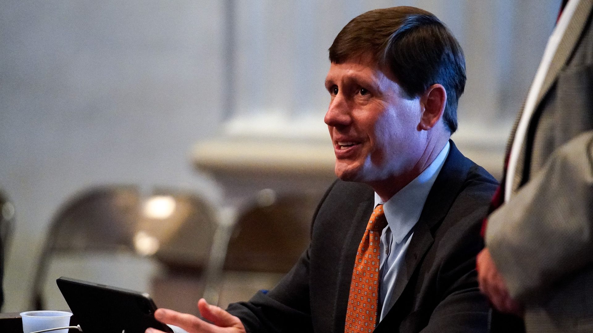 Brian Kelsey looks up while sitting at a desk.