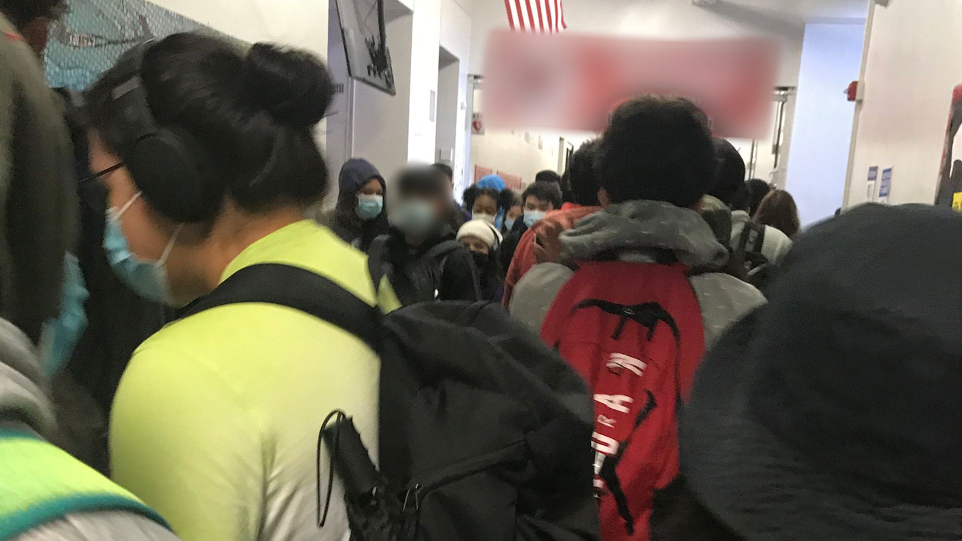 Kids in a crowded school hallway. 