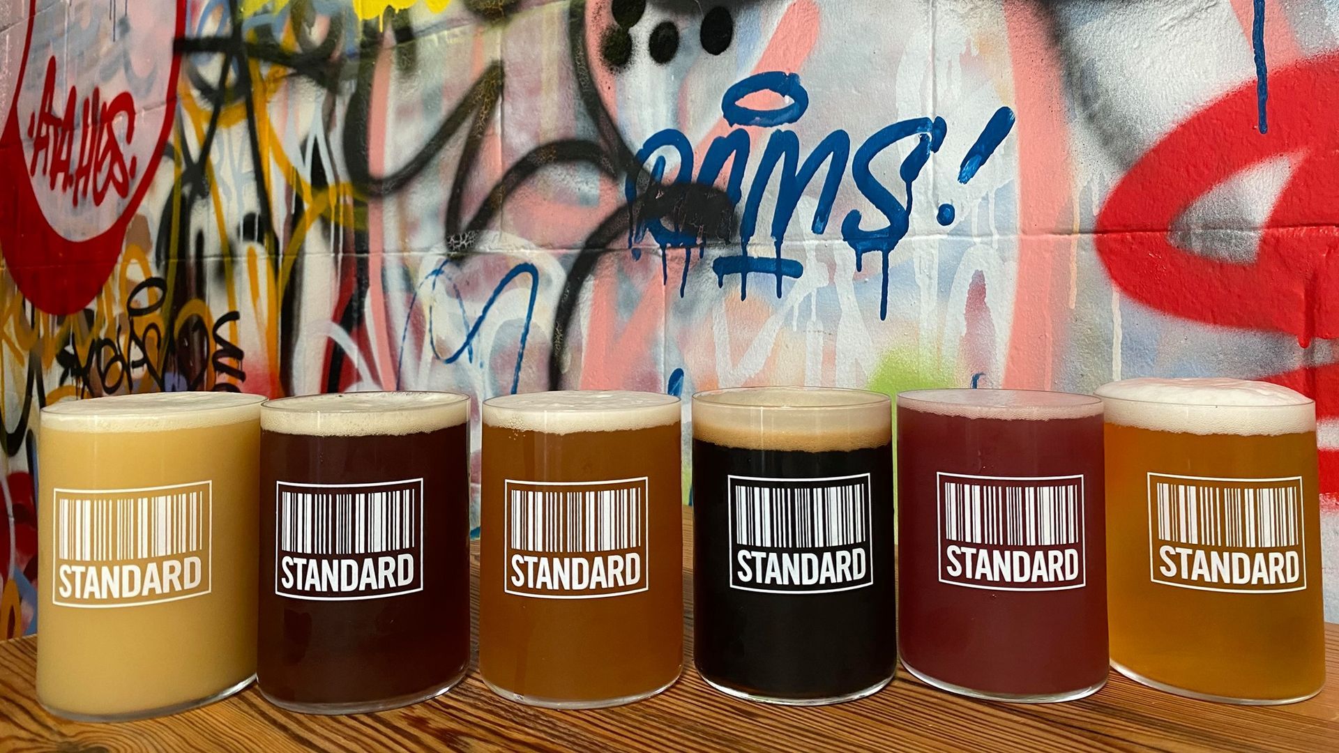 A lineup of beers in "Standard" branded glasses