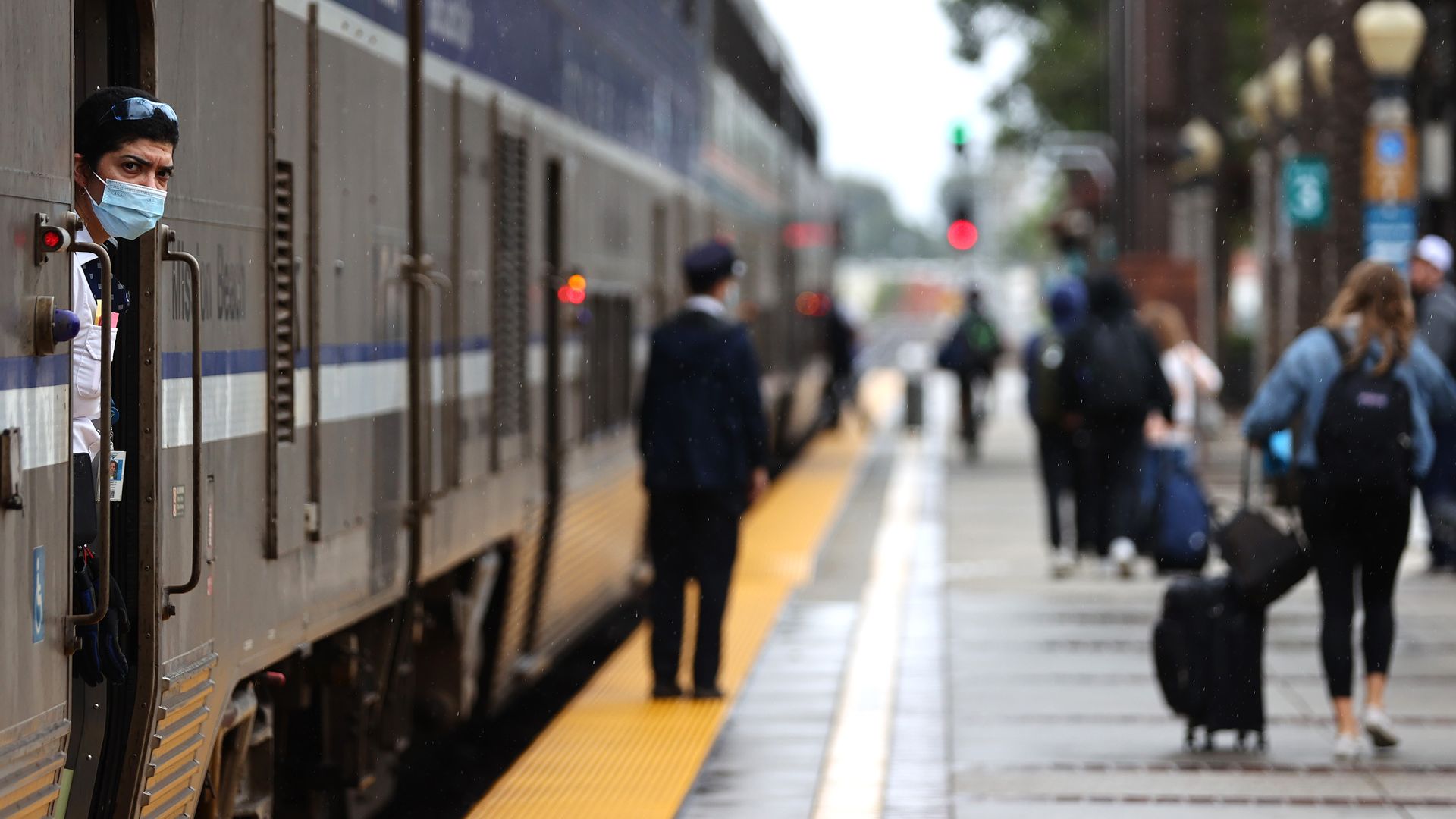 An Amtrak worker keeps watch from aboard an Amtrak train during a station stop on December 9, 2021 in Fullerton, California.