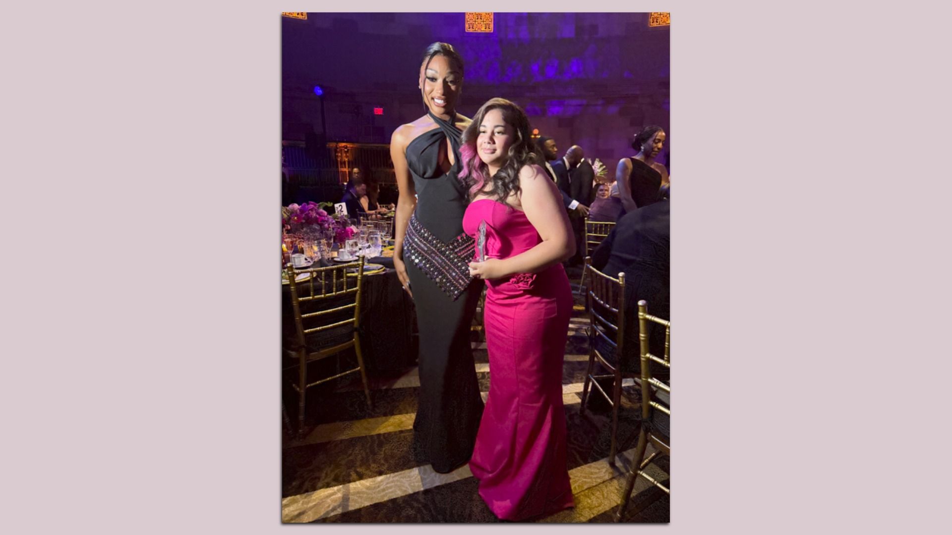 a pic of megan thee stallion with mila henry in evening gowns with a pink border around it