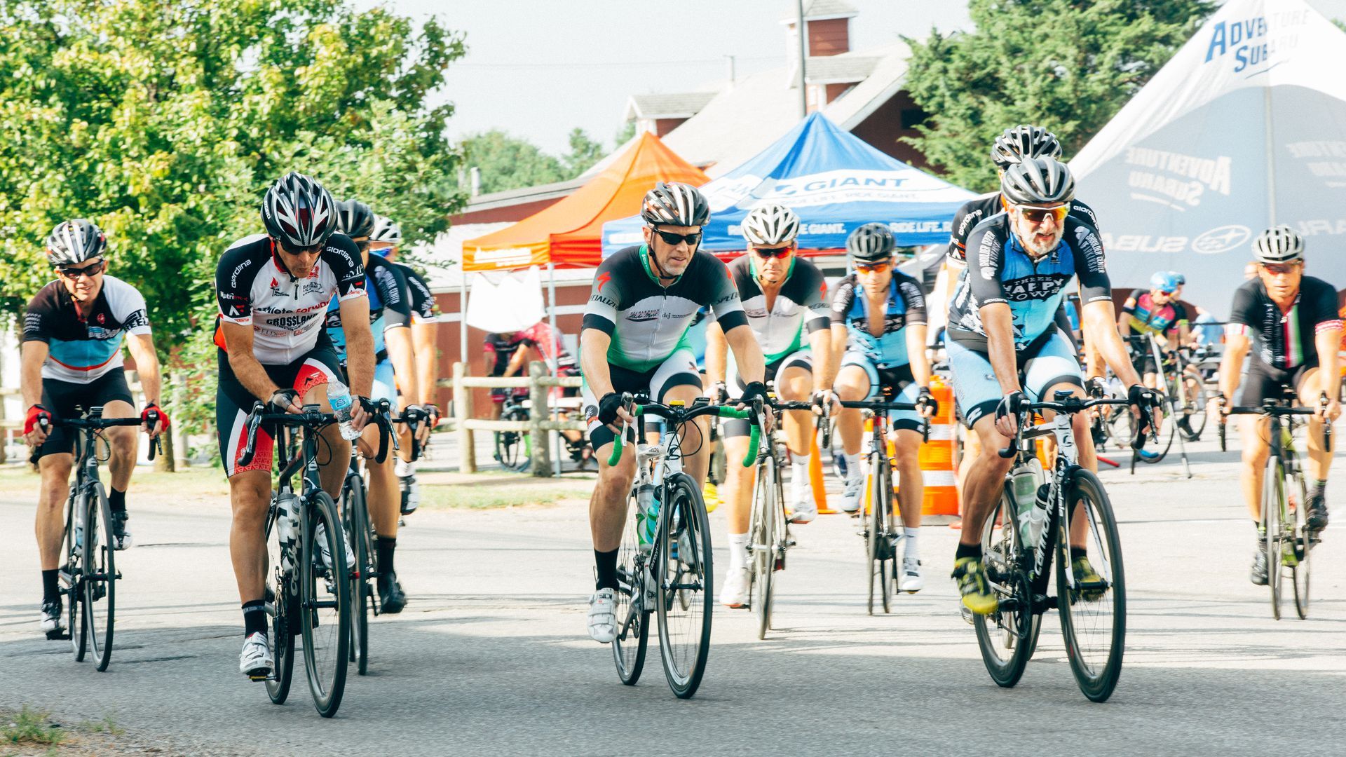 Cyclists ride their bikes down a street