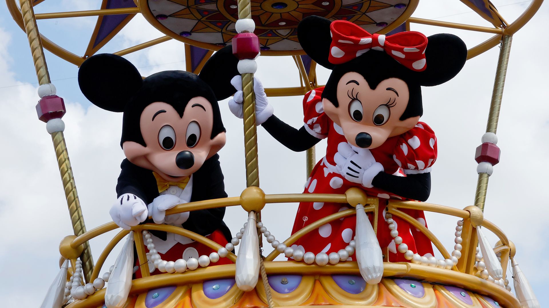 Actors dressed as Mickey and Minnie Mouse in a hot air balloon at a Disney park