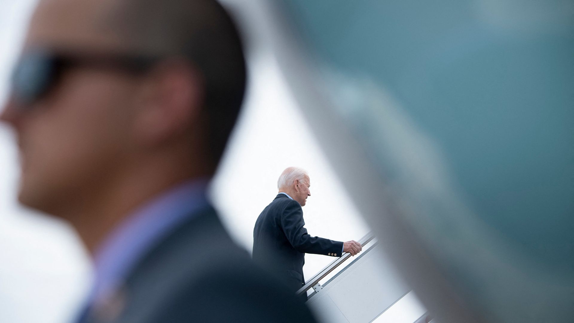 President Biden is seen walking up the steps of Air Force One as he departs for Europe.