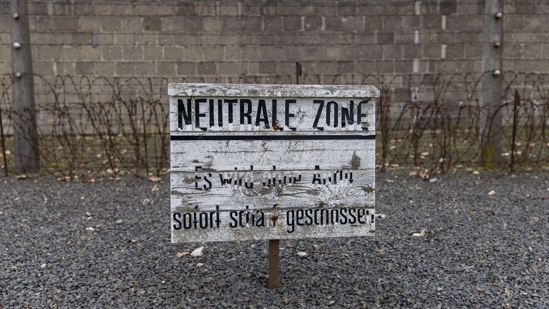 A fading banner reads "Neutral zone, it will be shot at without a warning" at the Sachsenhausen concentration camp memorial in Oranienburg, Germany.