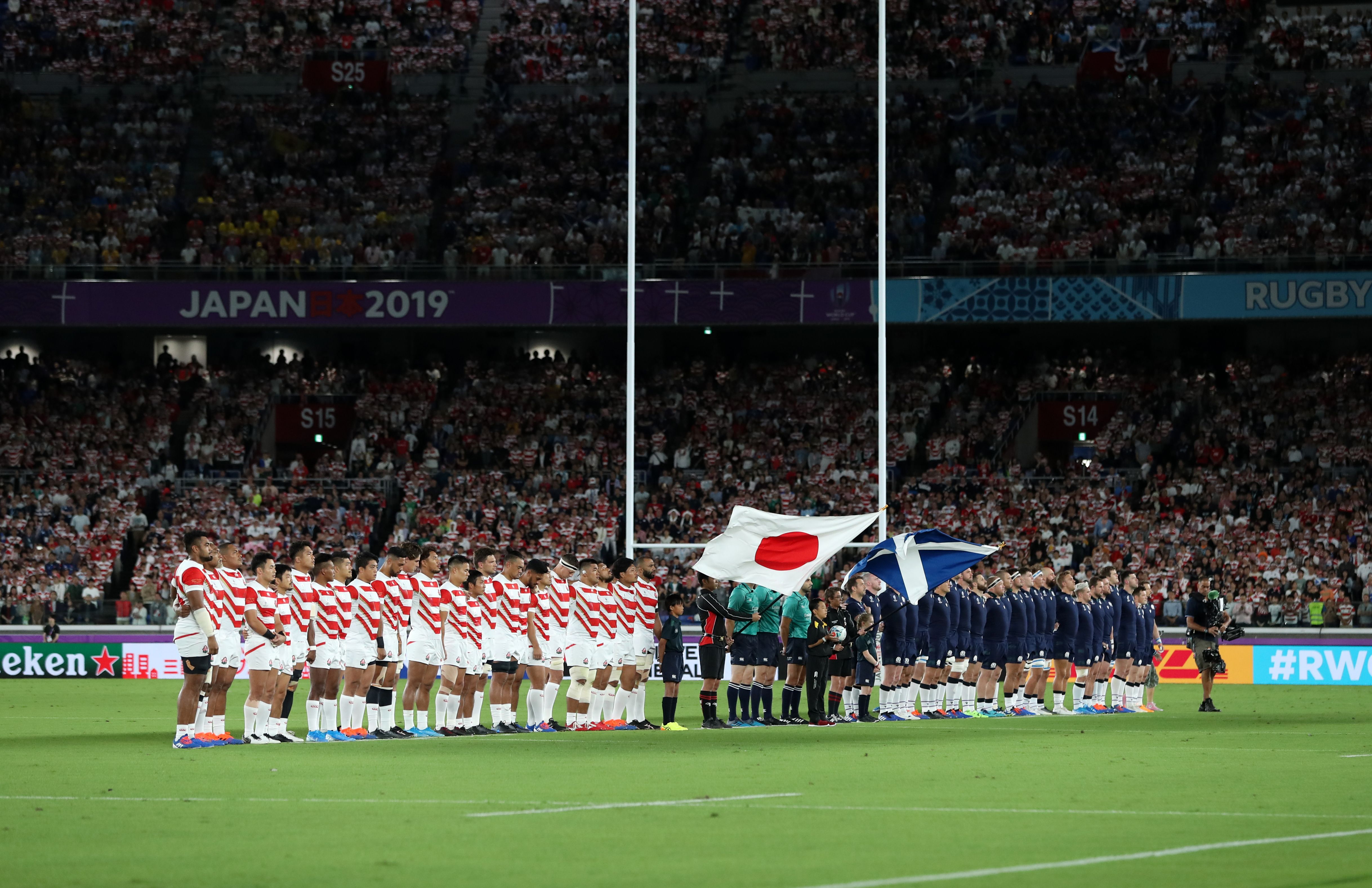 Japan and Scotland observe a minutes silence for the victims of Typhoon Hagibis during the 2019 Rugby World Cup match at the Yokohama Stadium, Yokohama. 
