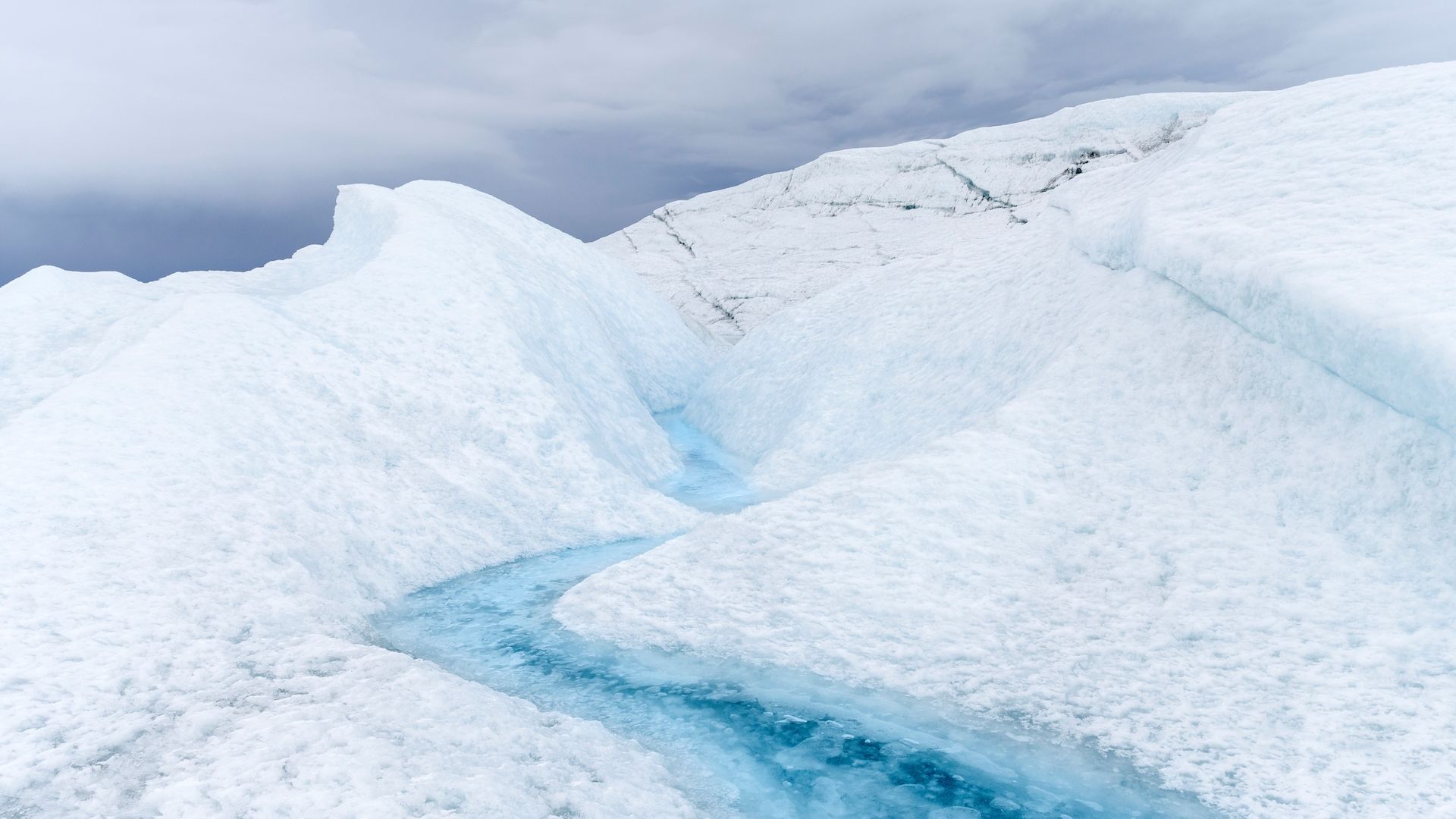 Meltwater courses through the Greenland Ice Sheet.