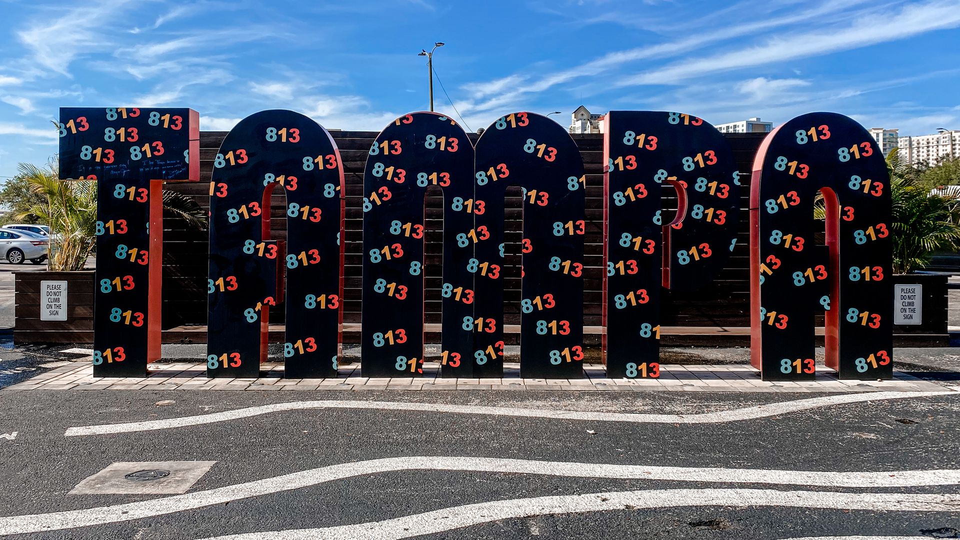 sign that says TAMPA with 813 stickers all over the letters