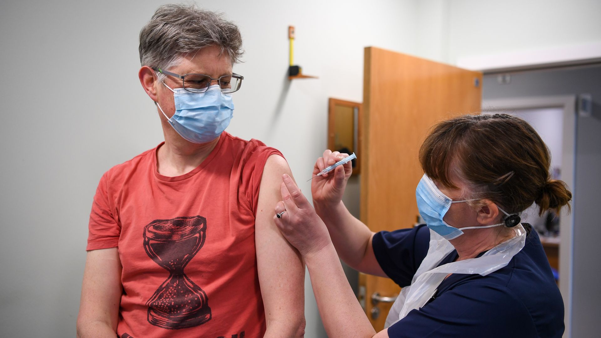 A vaccinators administering a coronavirus vaccine in medical center in Bridgeport, England.