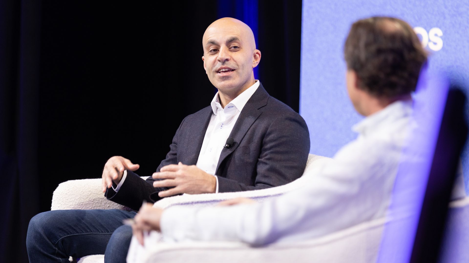 Databricks CEO Ali Ghodsi speaking on stage